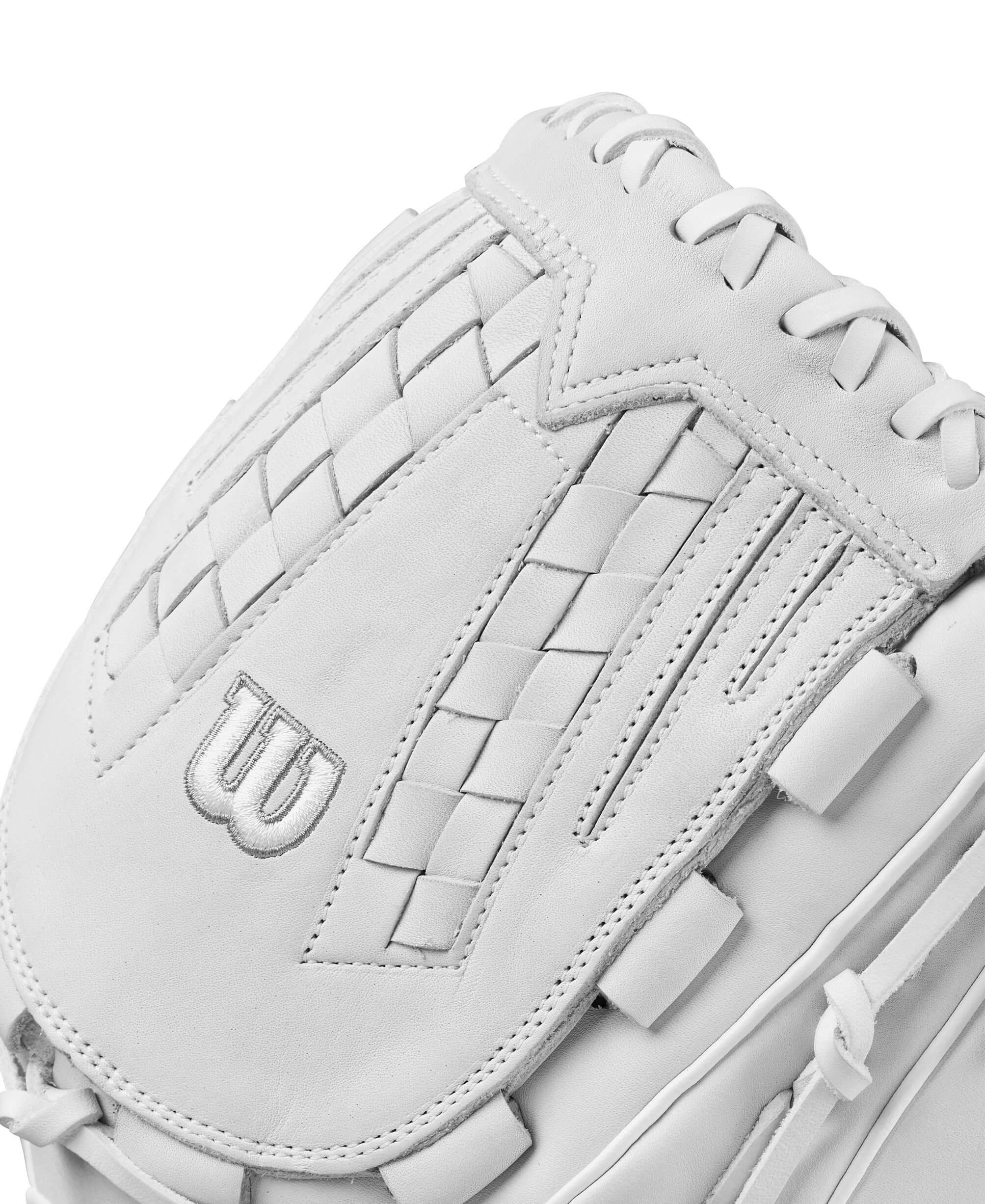 Close-up of Wilson A1000FP V125 fastpitch softball glove showing white leather and Closed Victory Web design.