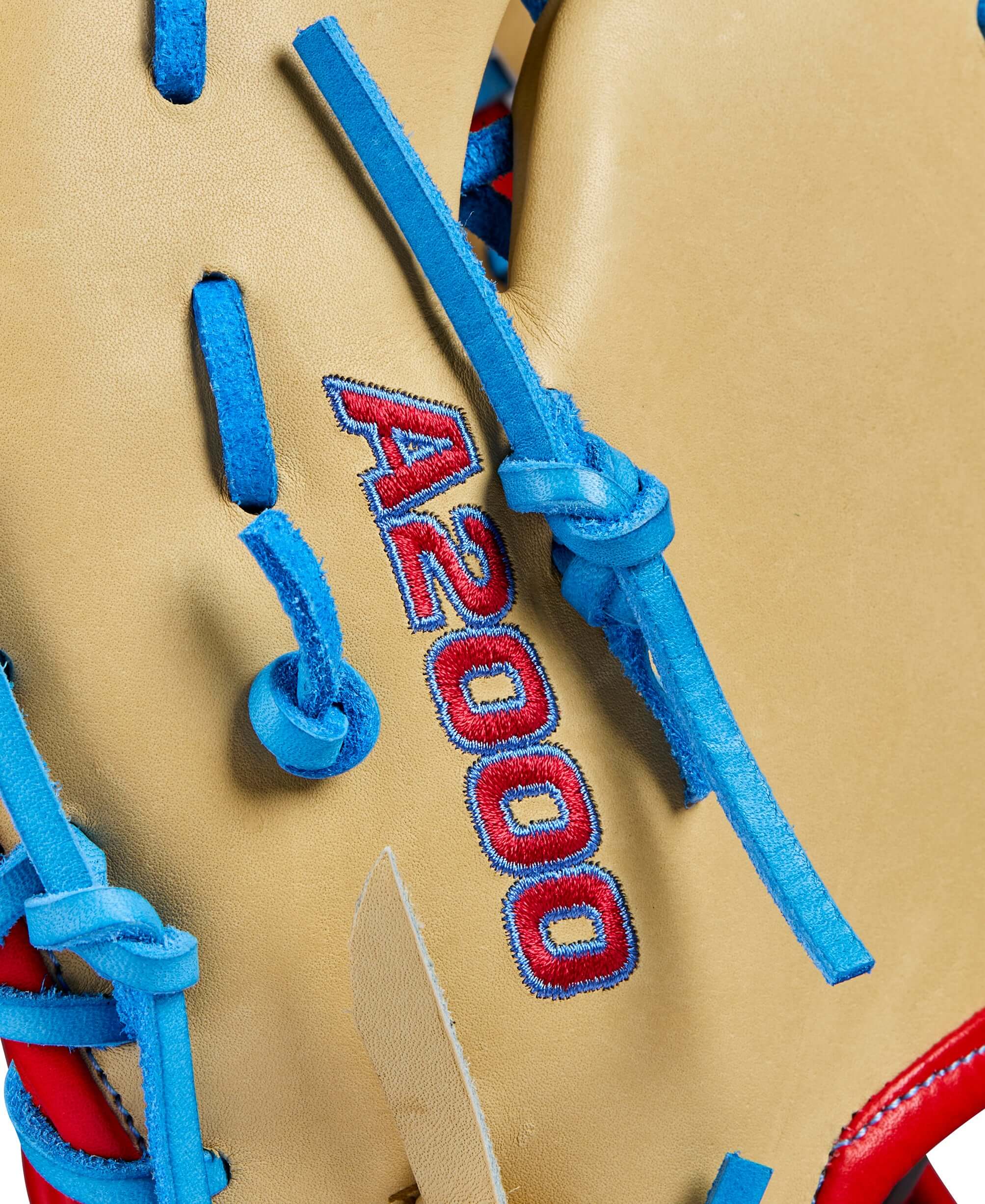 Close-up of Wilson A2000 1677 baseball mitt showcasing Blonde Pro Stock leather and blue laces.