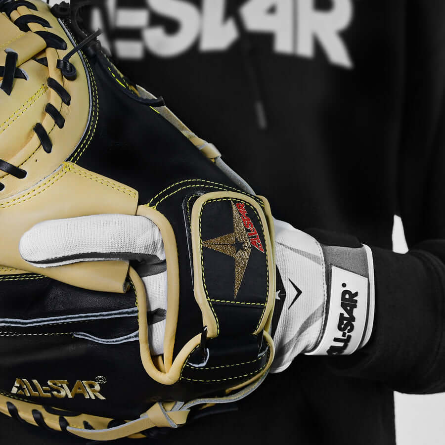 All-Star youth protective padded catcher's inner glove showcased on a player's hand, highlighting comfort and safety features.