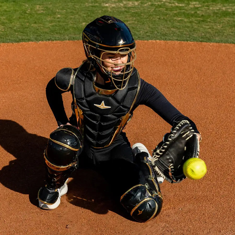 Catcher in All-Star PHX™ Diamond Series Softball Catcher's Kit | Black/Gold, in action on field, facing forward.