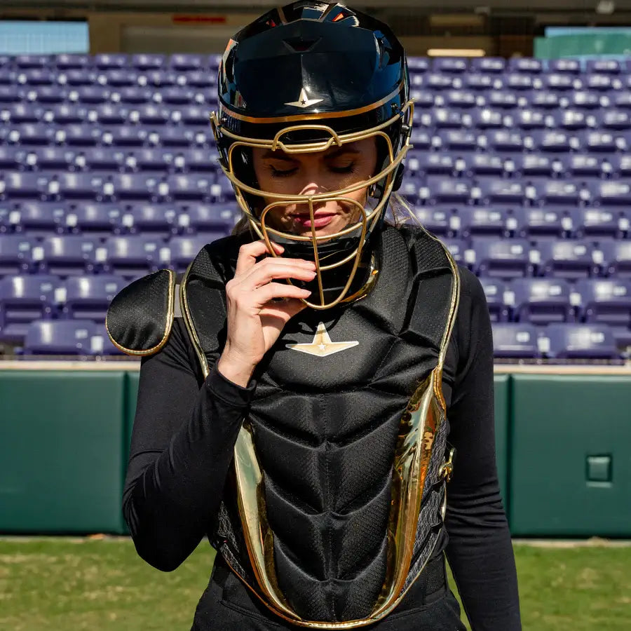 Front view of All-Star PHX™ Diamond Series Softball Catcher's Kit in Black/Gold with gold chest protector and helmet.
