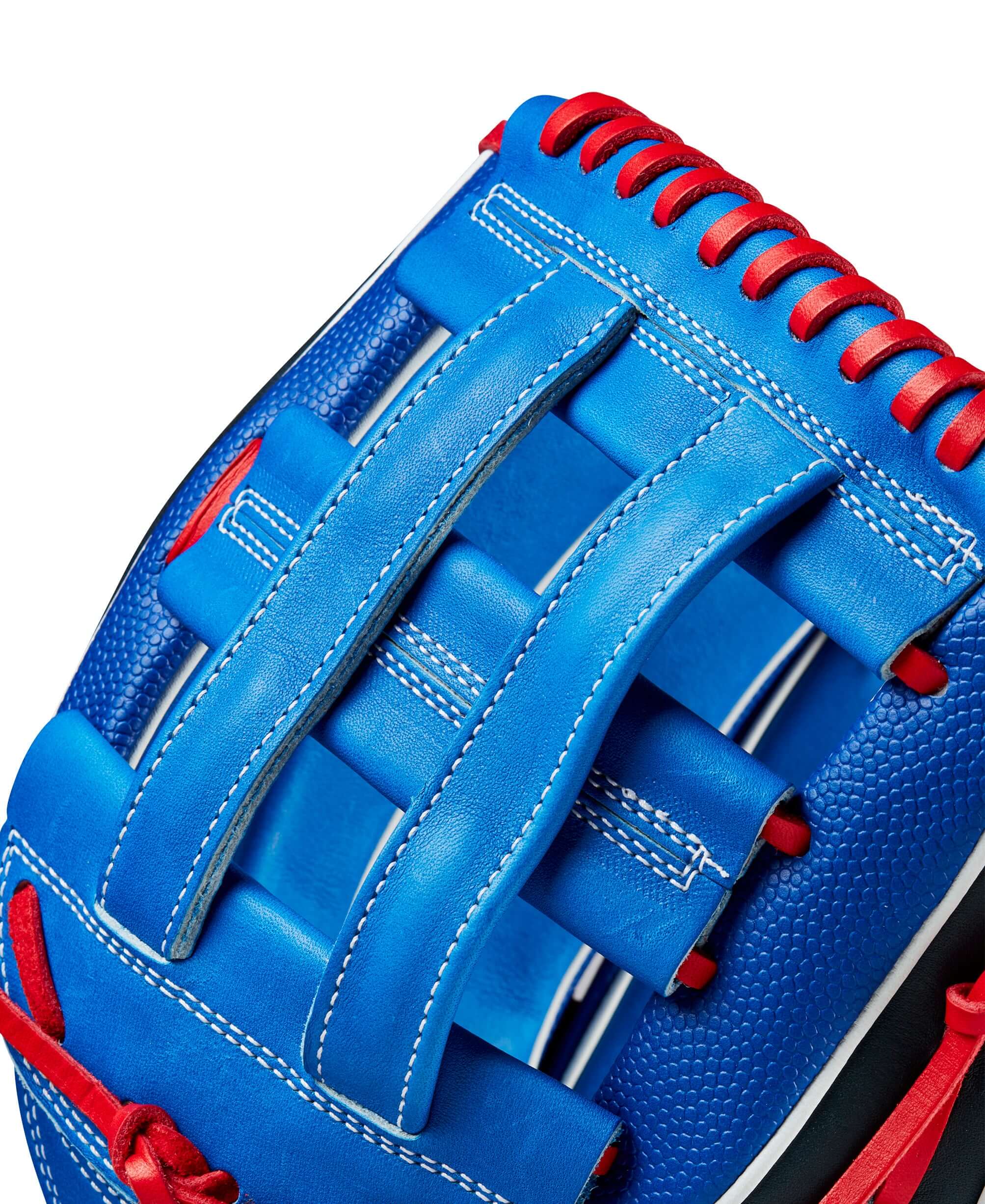 Close-up of Wilson 2024 A2K Mookie Betts game model glove with blue and red design, showcasing durable leather and webbing details.