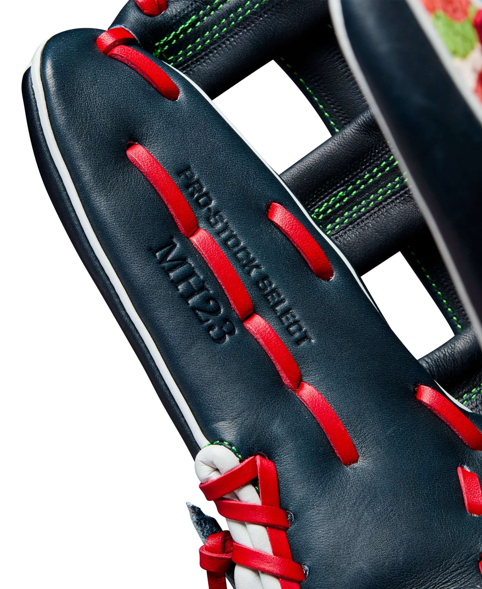 Close-up of Wilson A2K Michael Harris glove showing leather details and vibrant red lacing.