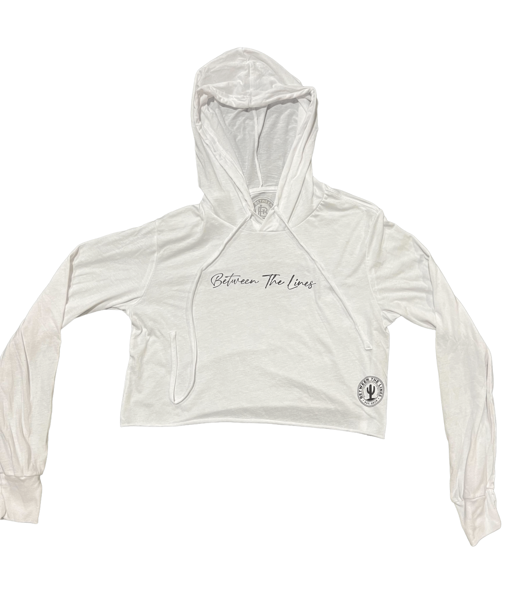 Between The Lines women's long sleeve hoodie crop top in white with drawstring and logo, perfect for stylish comfort.
