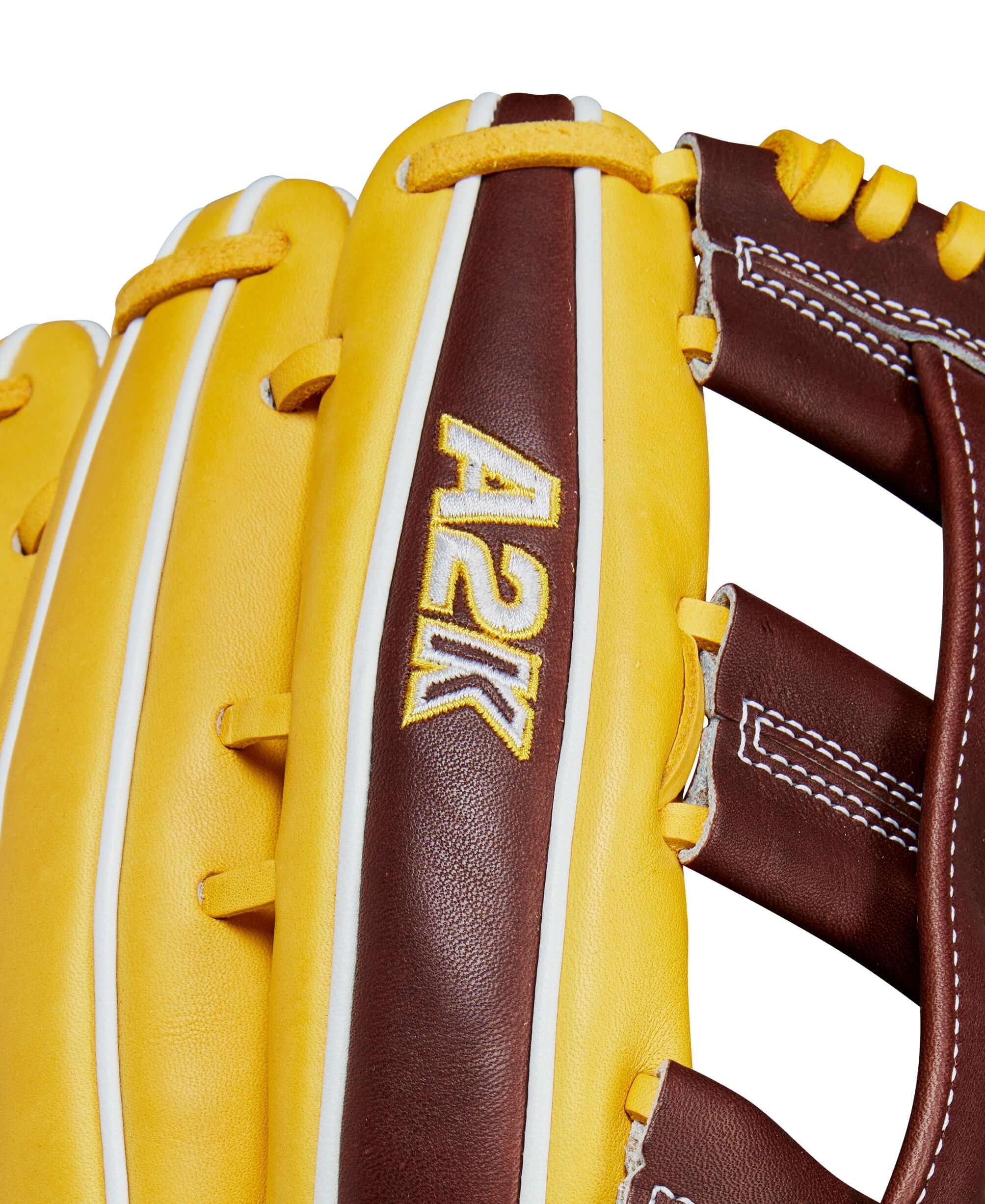 Close-up of Wilson A2K Juan Soto outfield glove showcasing yellow and brown leather with A2K logo.
