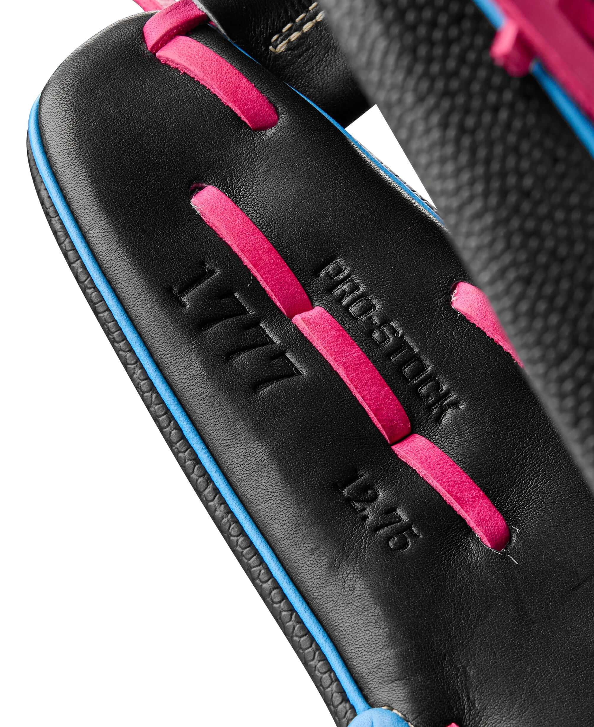 Close-up of Wilson A2000 1777SS glove showing black leather and pink stitching details, highlighting 12.75" design.