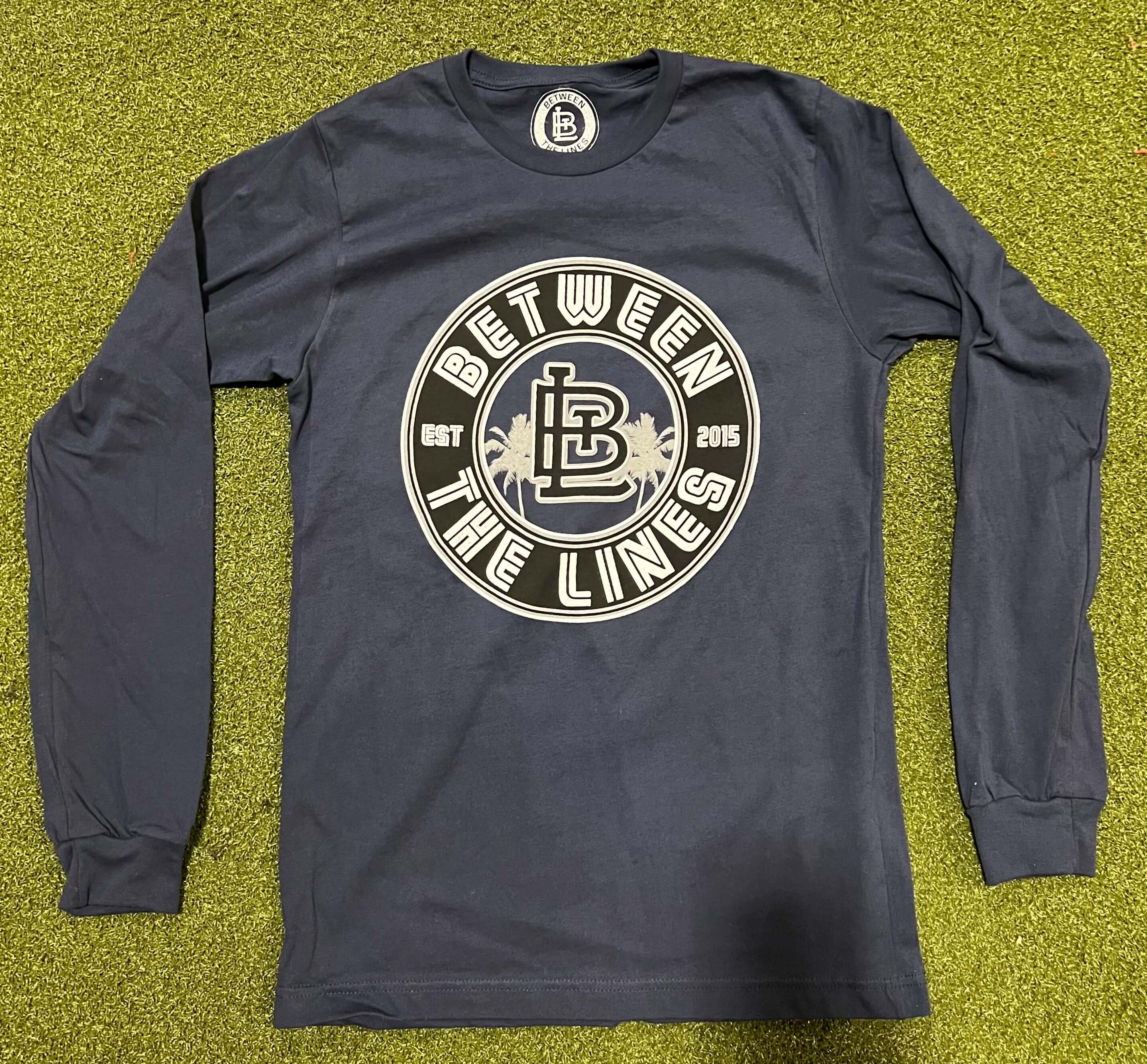 Long sleeve shirt featuring Between The Lines logo, stylish and comfortable for casual wear.