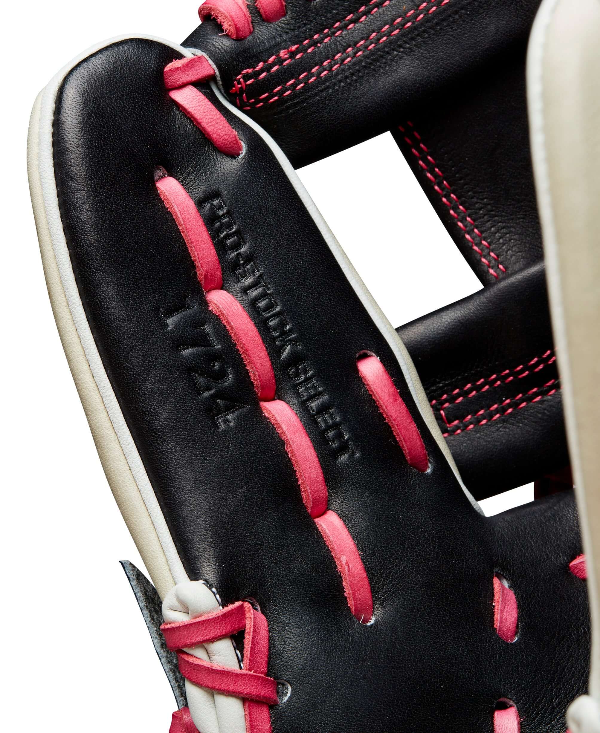 Close-up of the Wilson A2K 1724 glove showing Pro Stock® Select leather with bold pink stitching accents.