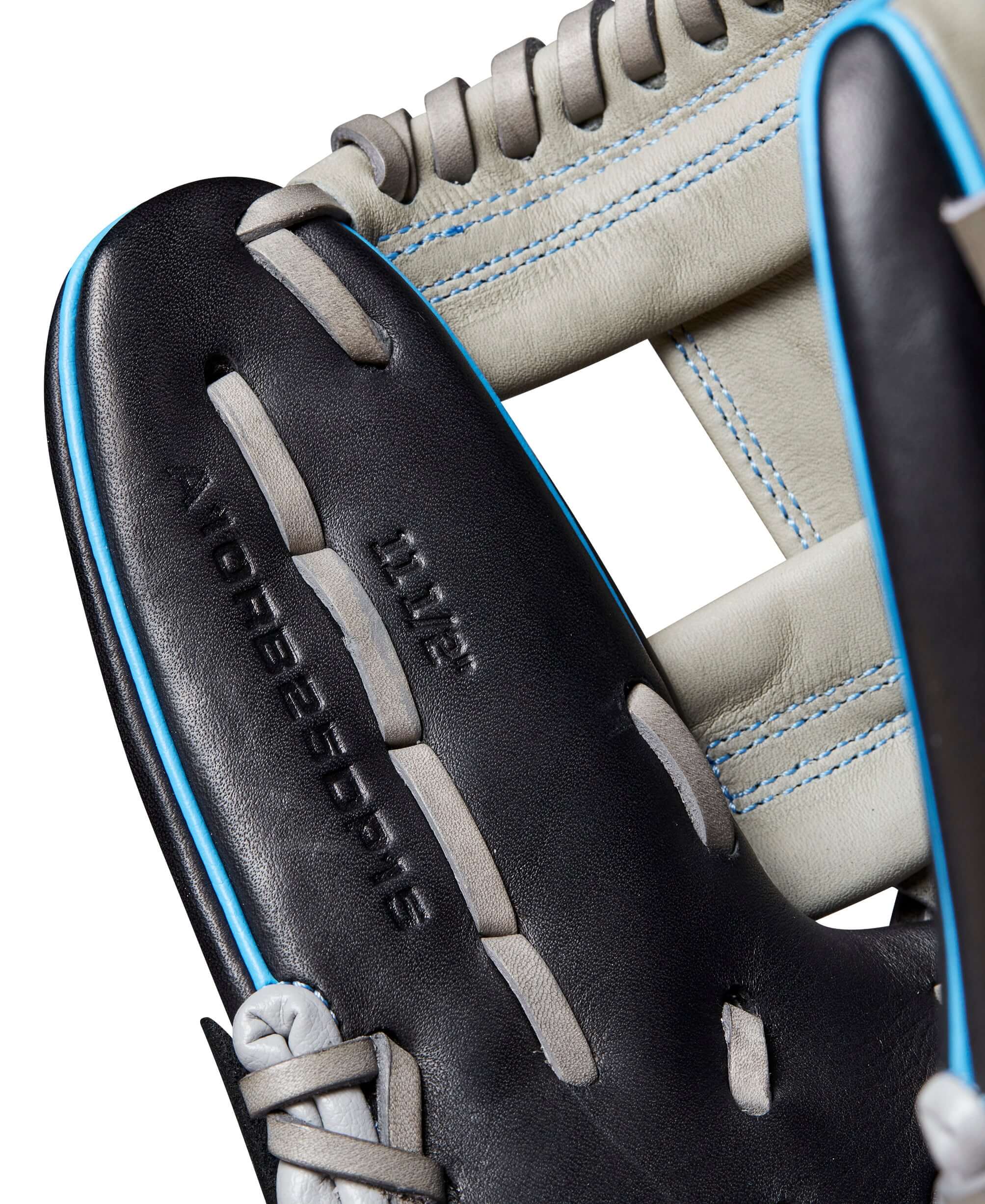 Close-up of Wilson A1000 DP15 glove showcasing black leather and cool blue stitching details. Ideal for young infielders.