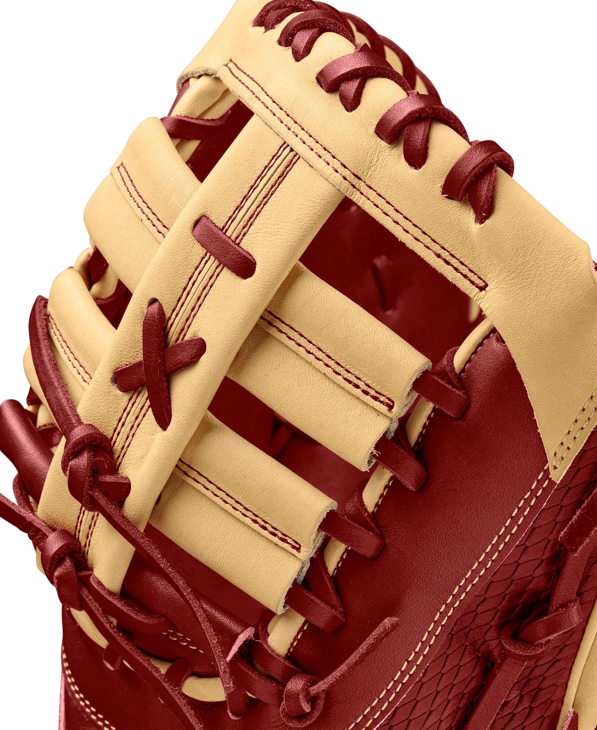 Close-up of Wilson A2K 1679 baseball mitt showcasing Blonde & Brick Red leather lacing and reinforcements.