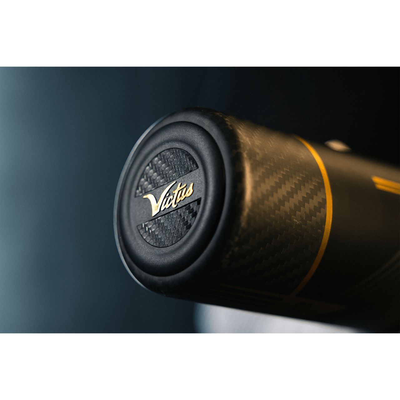 Close-up of the Victus Baseball Bat handle, showcasing carbon composite design and brand logo.