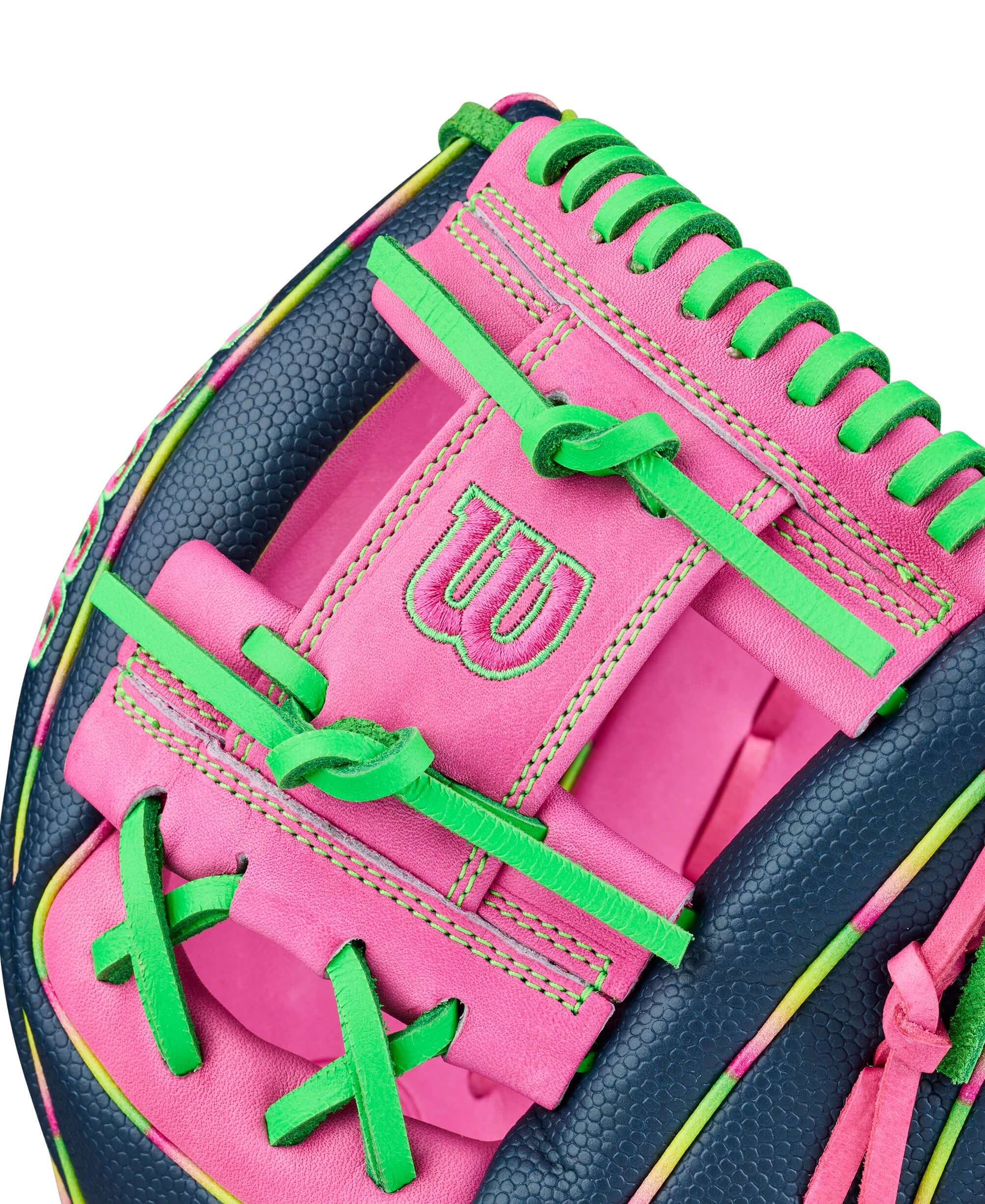 Web detail of Wilson Glove of the Month (GOTM) June 2026 A2000 1724 with flamingo pink palm, neon green lacing, navy leather.