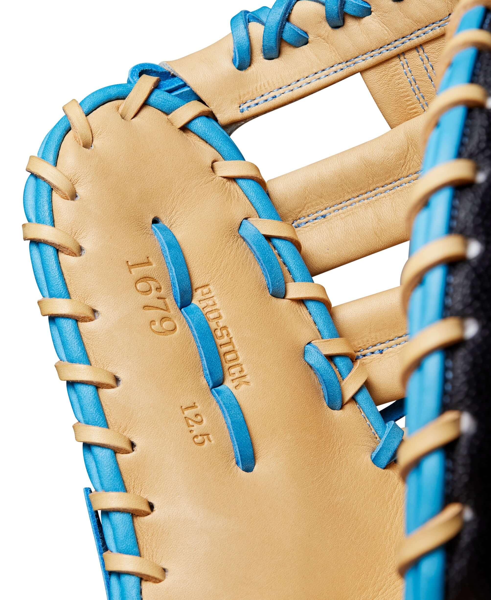 Close-up of Wilson A2000 1679SS first base mitt interior showing Blonde Pro Stock leather and blue stitching details.