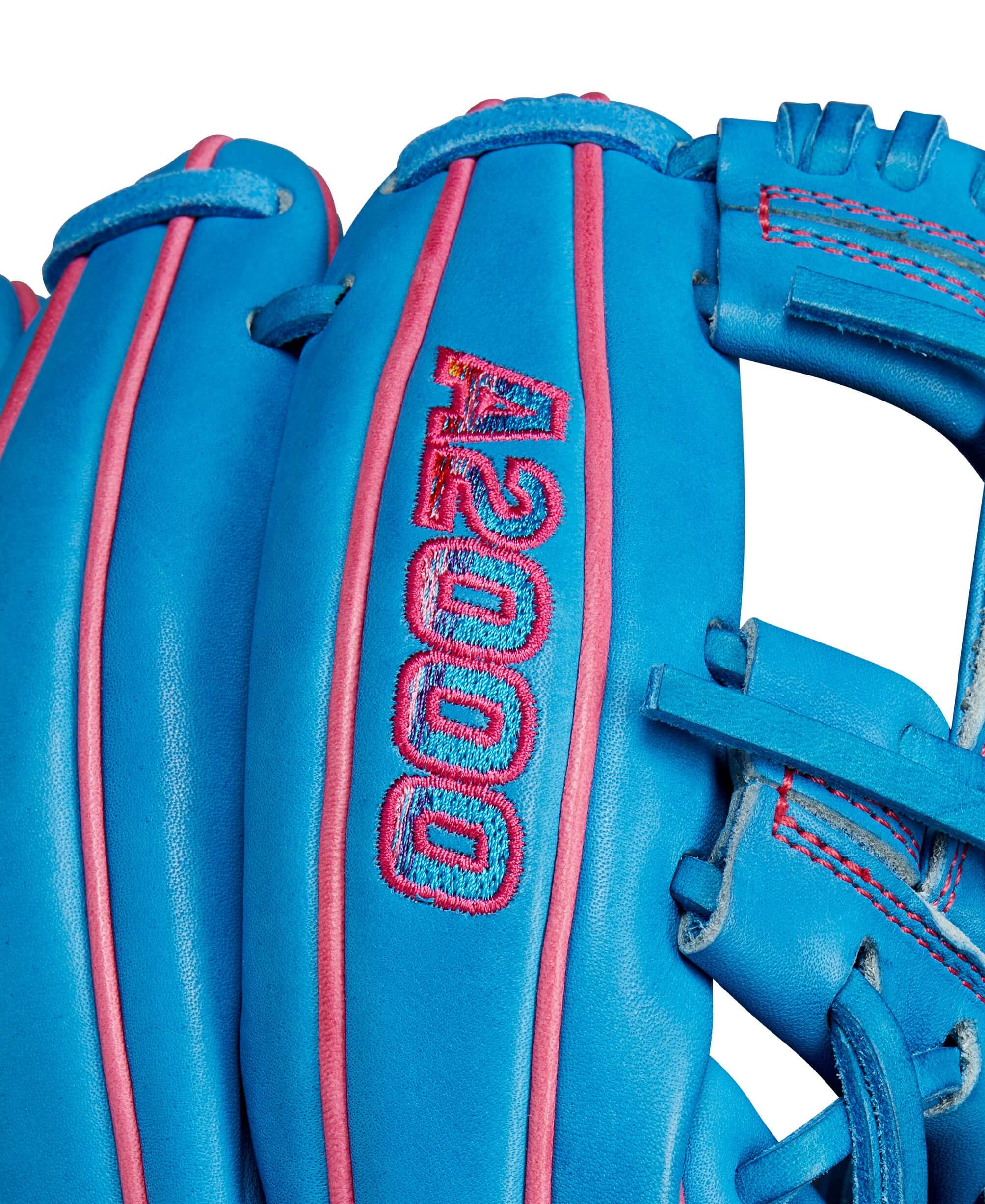 Close-up of the Wilson A2000 1786 glove featuring blue and pink design elements and the Autism Speaks logo.