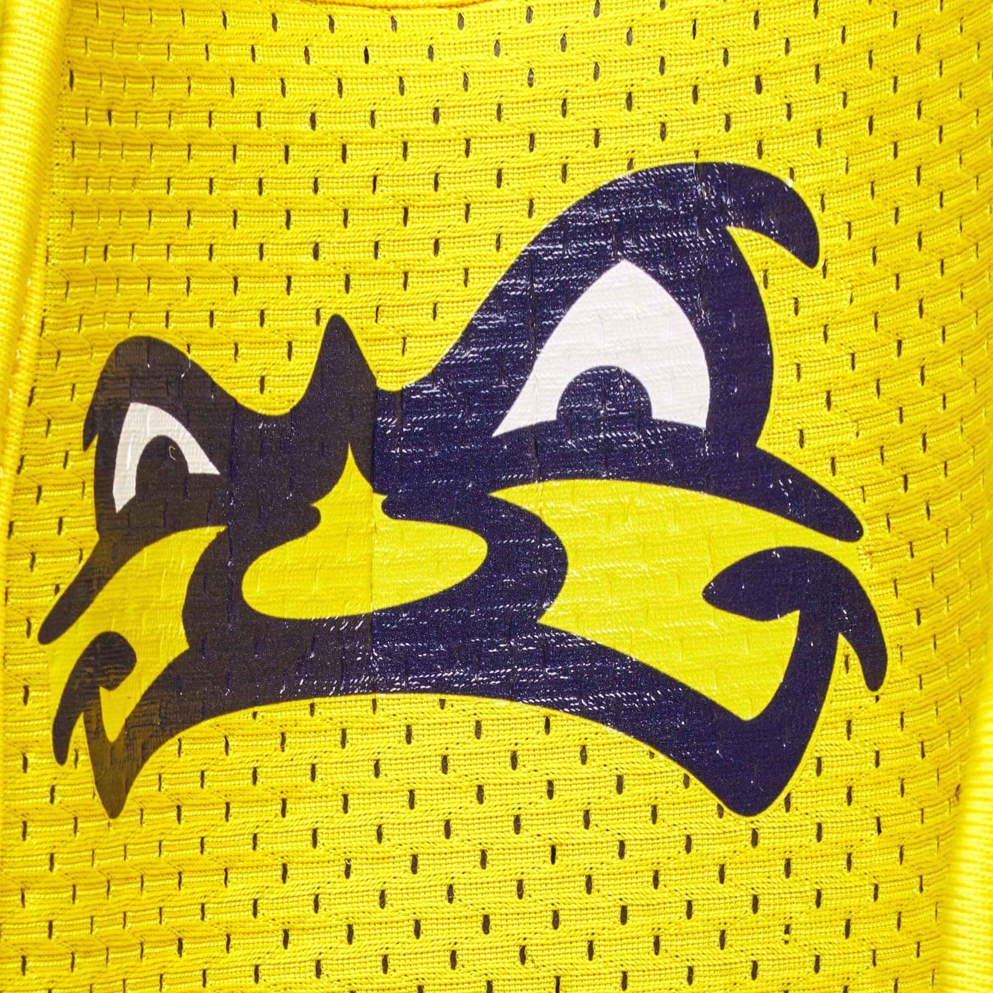 Close-up of the Savannah Bananas mascot logo on a bright yellow fabric, showcasing its playful design.