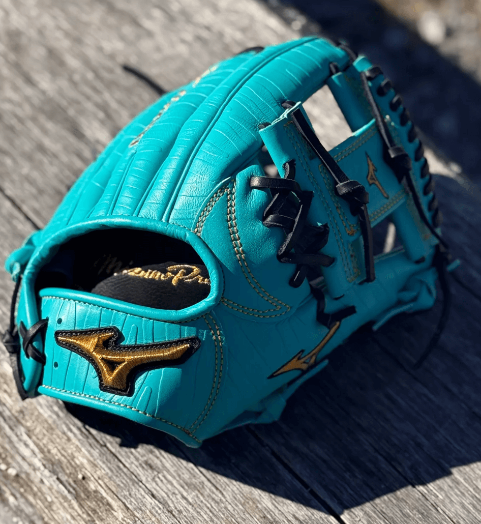 Mizuno GMP-400 ASTERISK PRO 11.5" LTO Baseball Glove in vibrant teal color on wooden surface.
