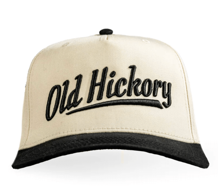 Front view of Old Hickory Script Snapback cap, featuring cream and black color with embroidered logo.