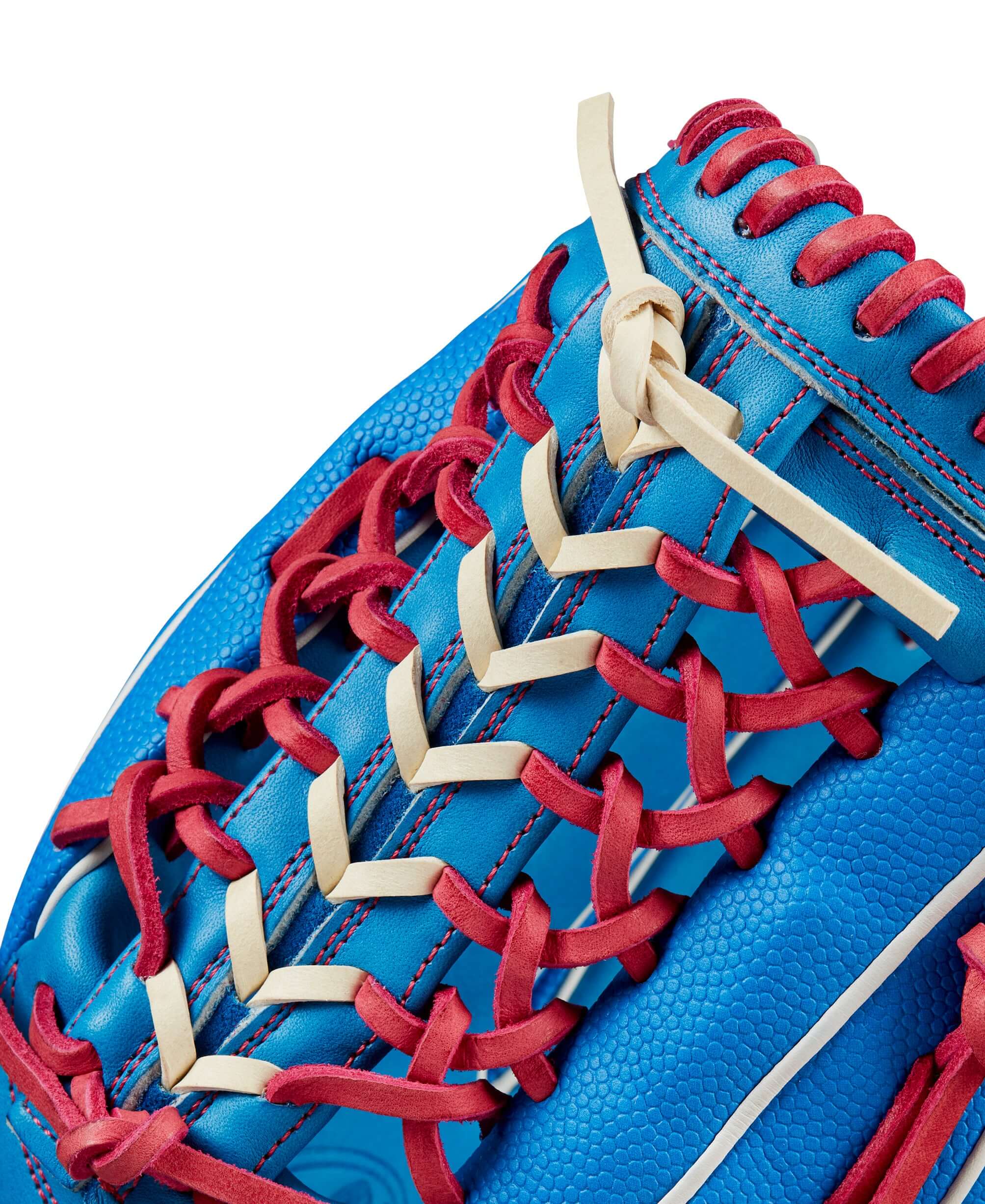 Close-up of Wilson 2024 Autism Speaks A2000 PF92SS baseball glove showing blue leather and red laces.