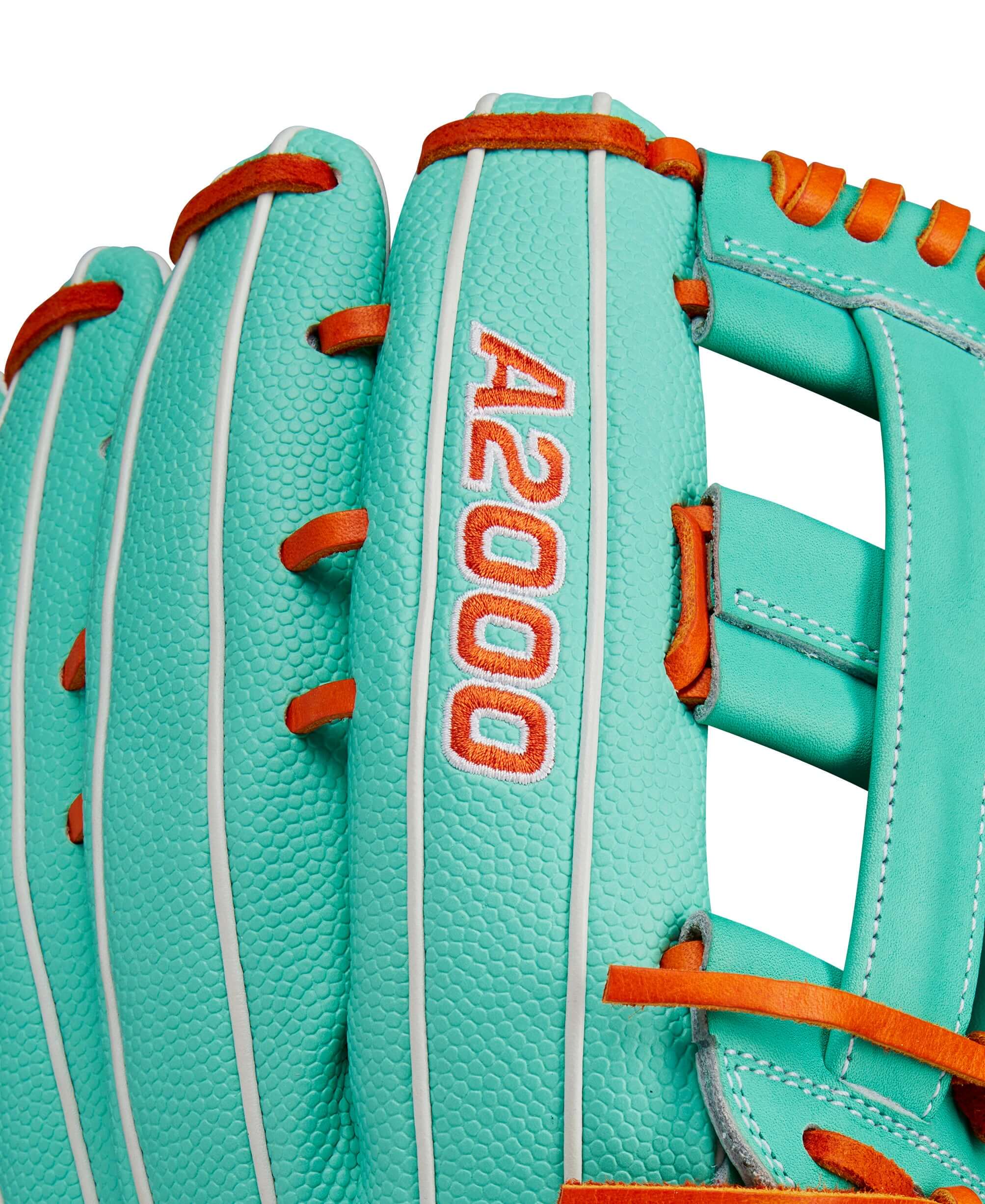 Close-up of Wilson A2000 glove in seafoam and orange with bold A2000 logo and Pro Stock leather texture.