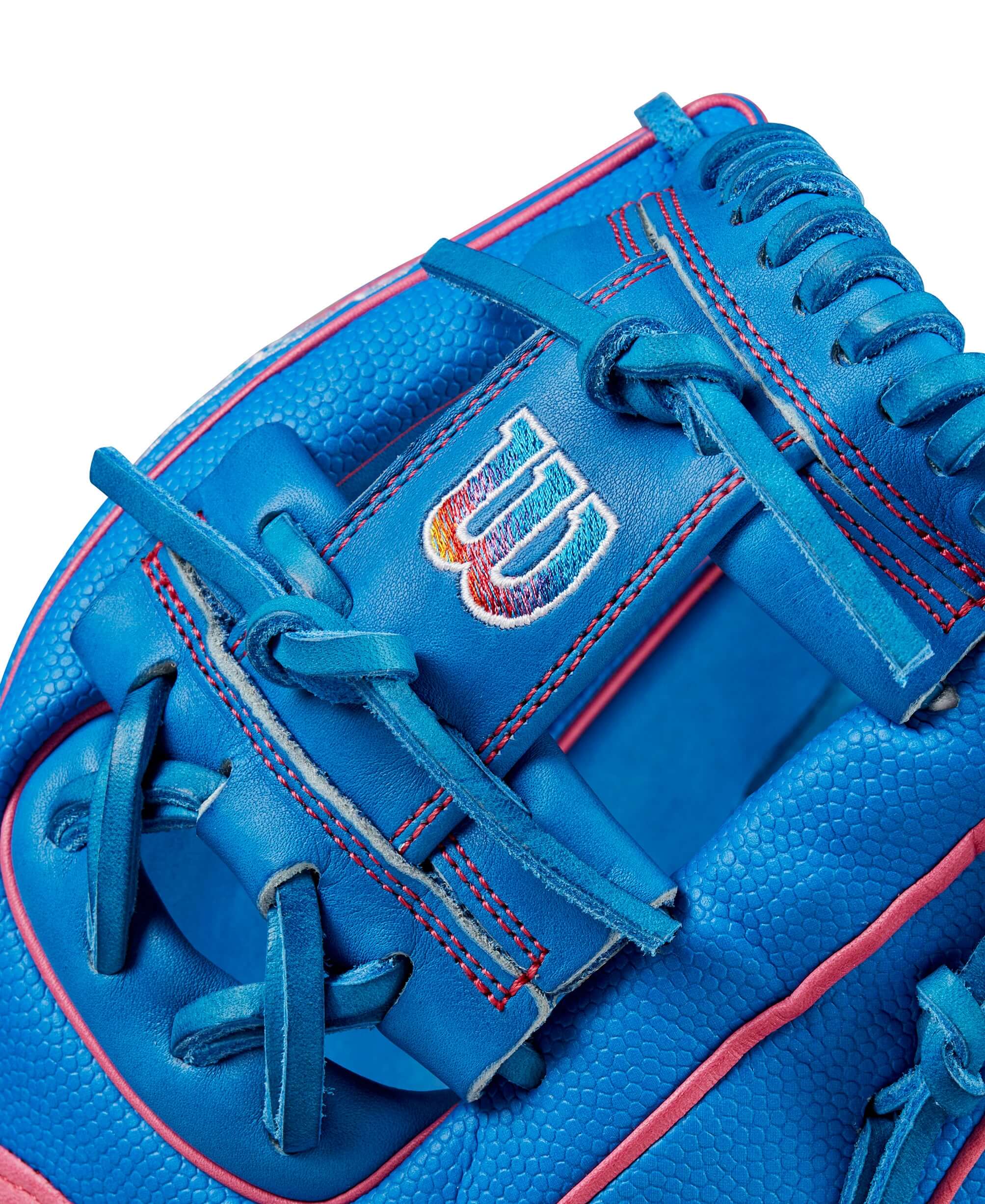 Close-up of the Wilson 2024 Autism Speaks A2000 DP15SS glove in blue with pink accents and logo detail.