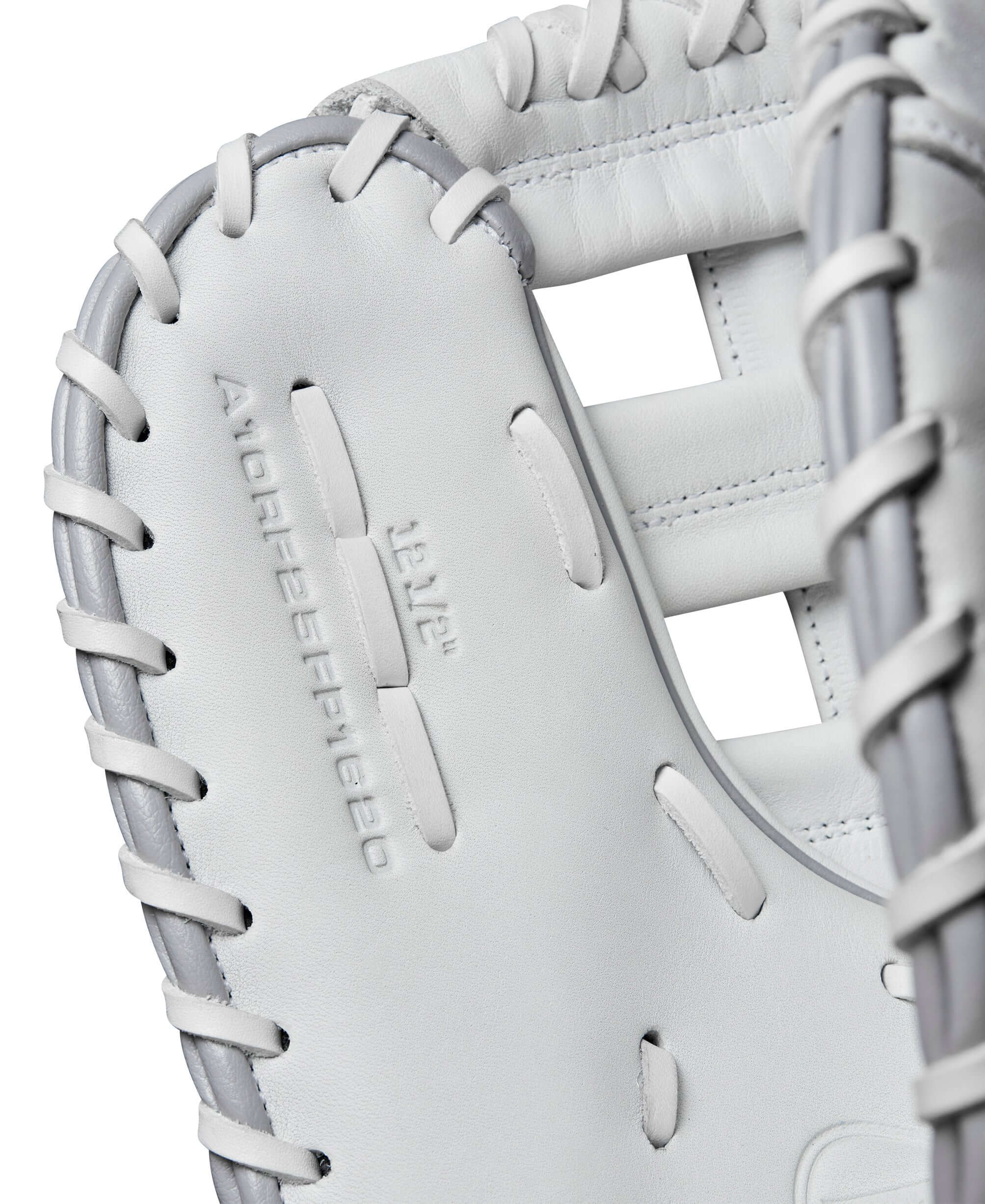 Close-up of Wilson 2025 A1000FP 1620 White/Grey Fastpitch Softball Glove, showcasing leather texture and stitching.