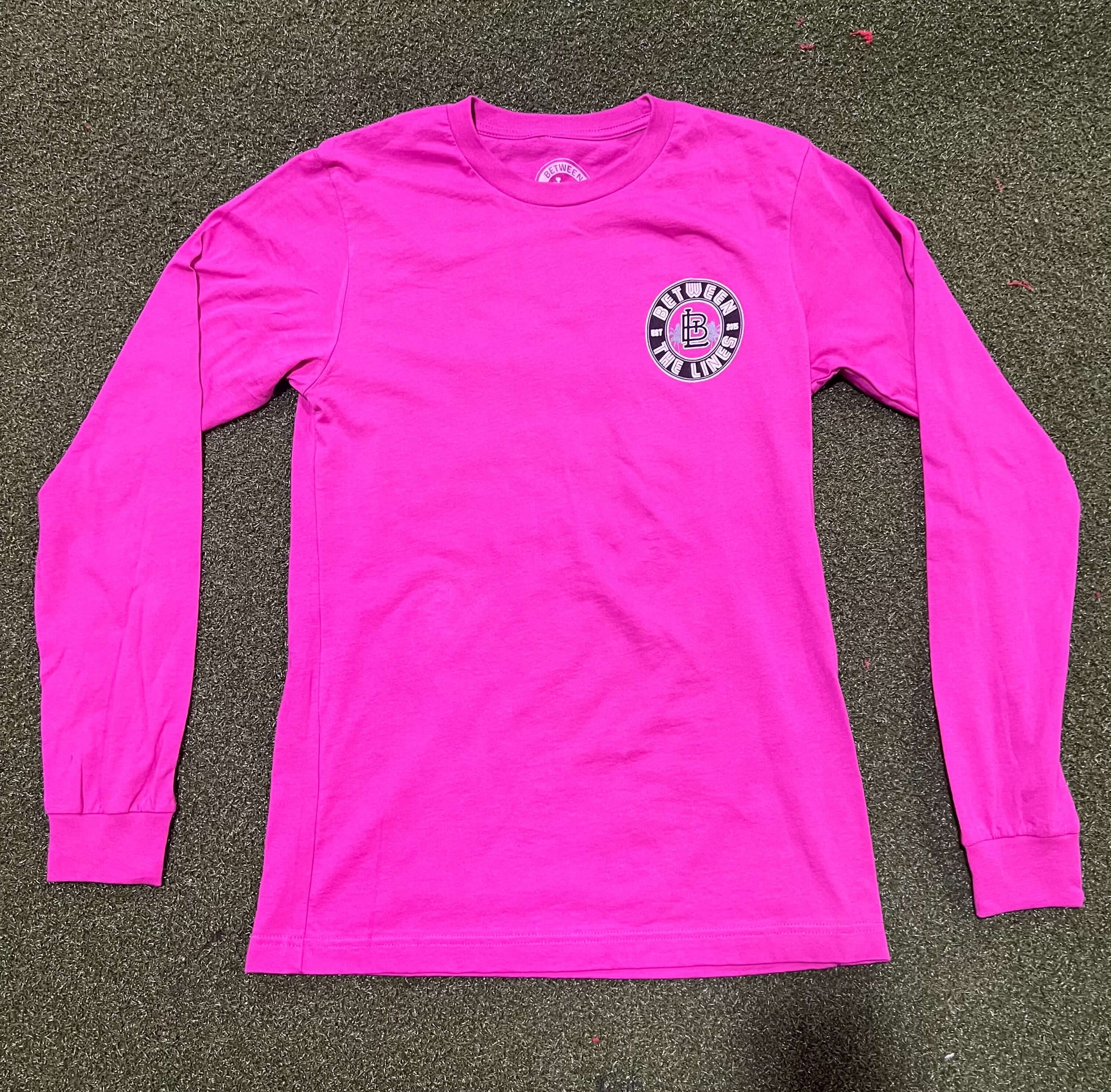 Bright pink long sleeve tee with a circular logo on the chest, perfect for casual outings and comfortable wear.