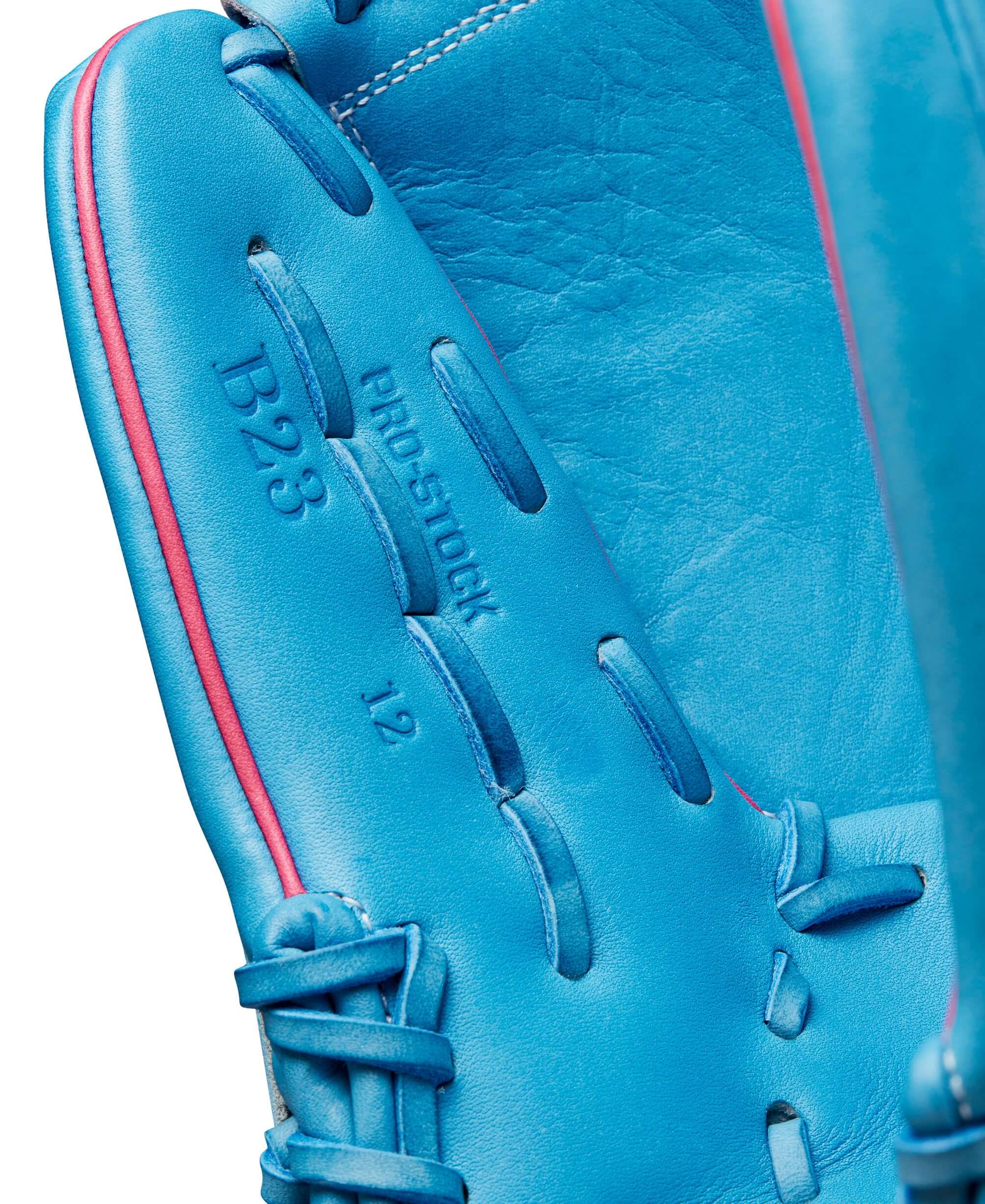 Detailed view of Wilson A2000 B23 glove in Sky Blue with Flamingo Pink accents, showcasing size 12 and Pro Stock label.