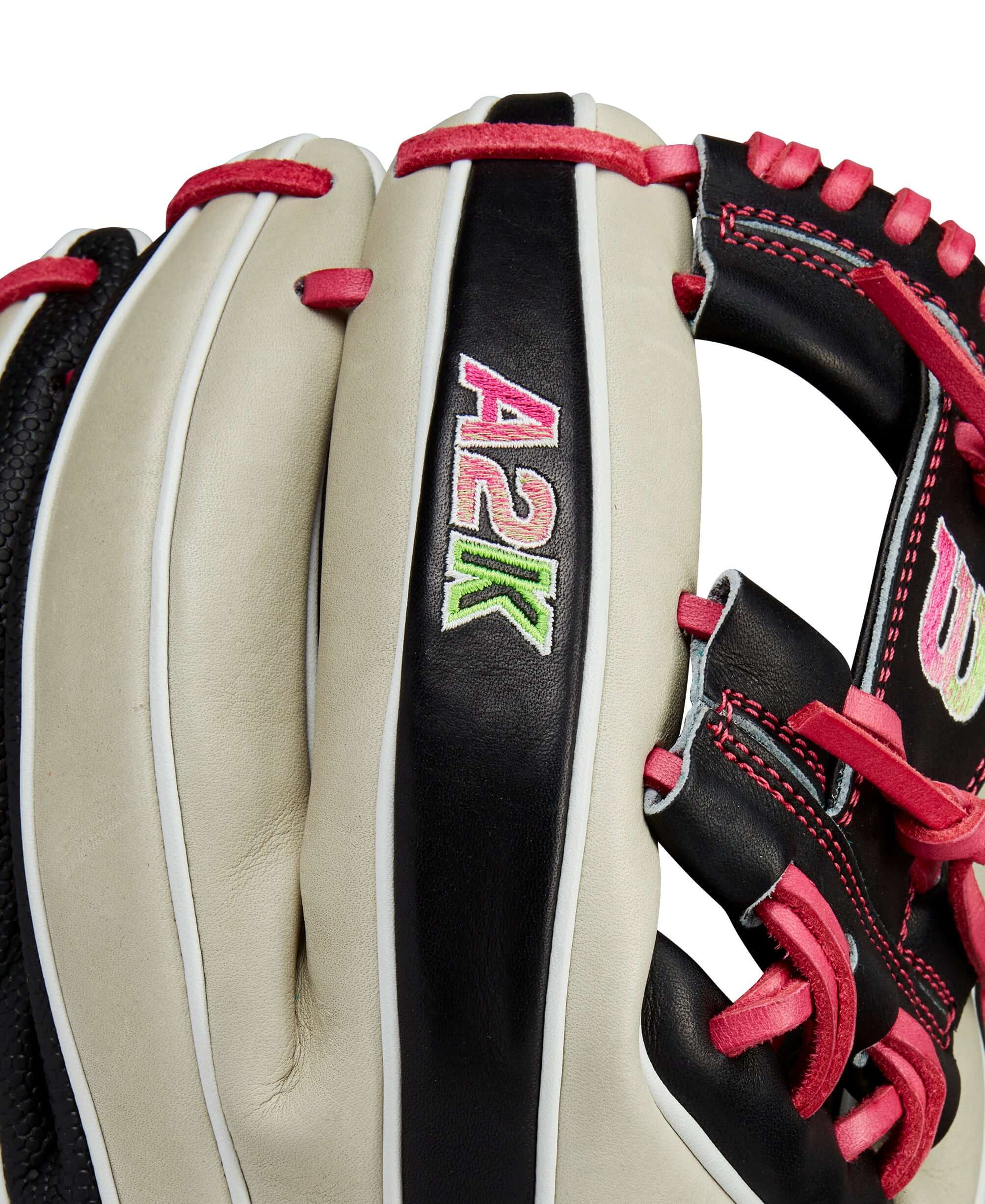 Close-up of Wilson A2K 1724 glove highlighting bold logos and Pro Stock leather design in black and pink.