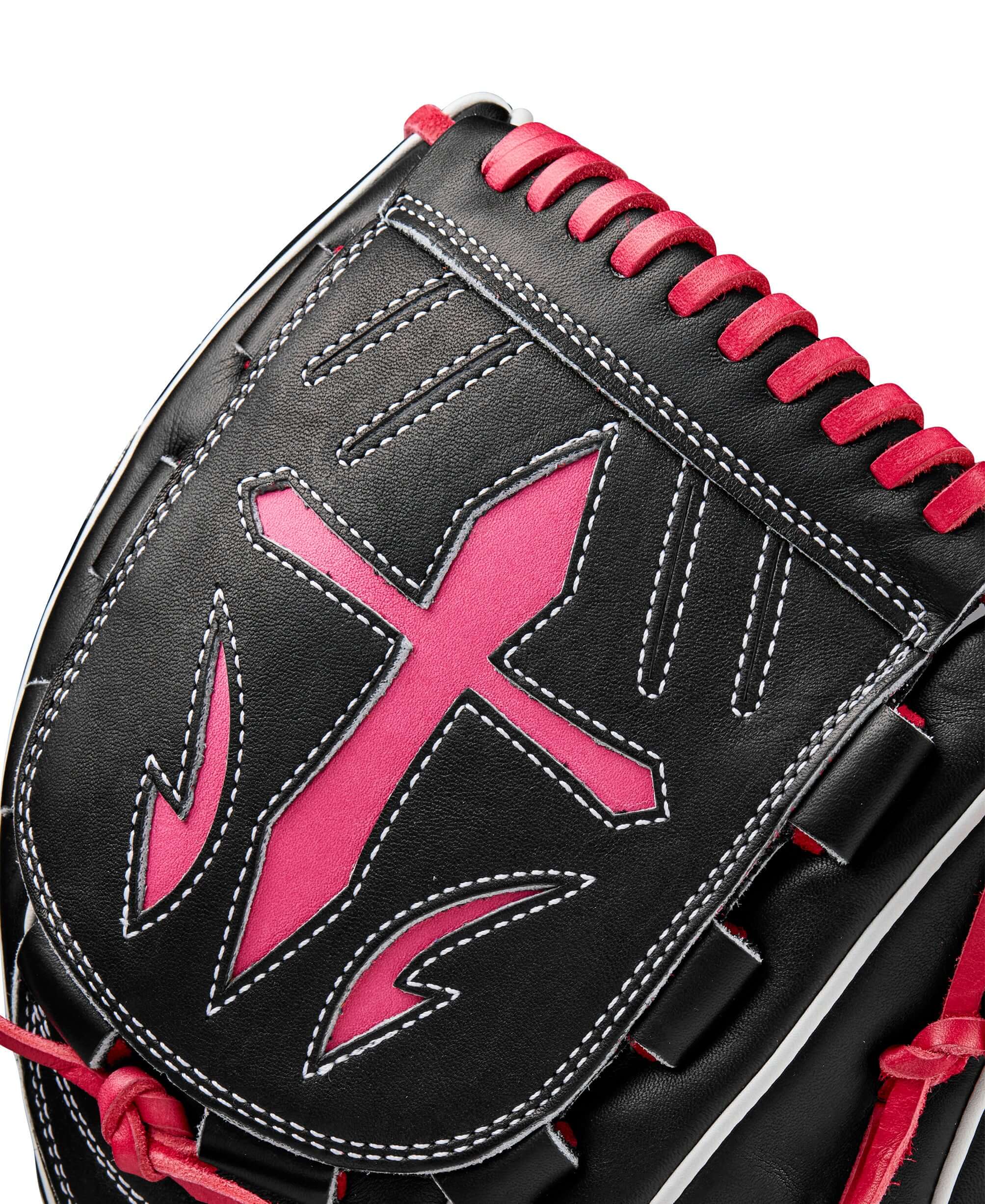 Wilson A2K B23 pitcher's glove close-up featuring black leather and pink accents with detailed stitching.