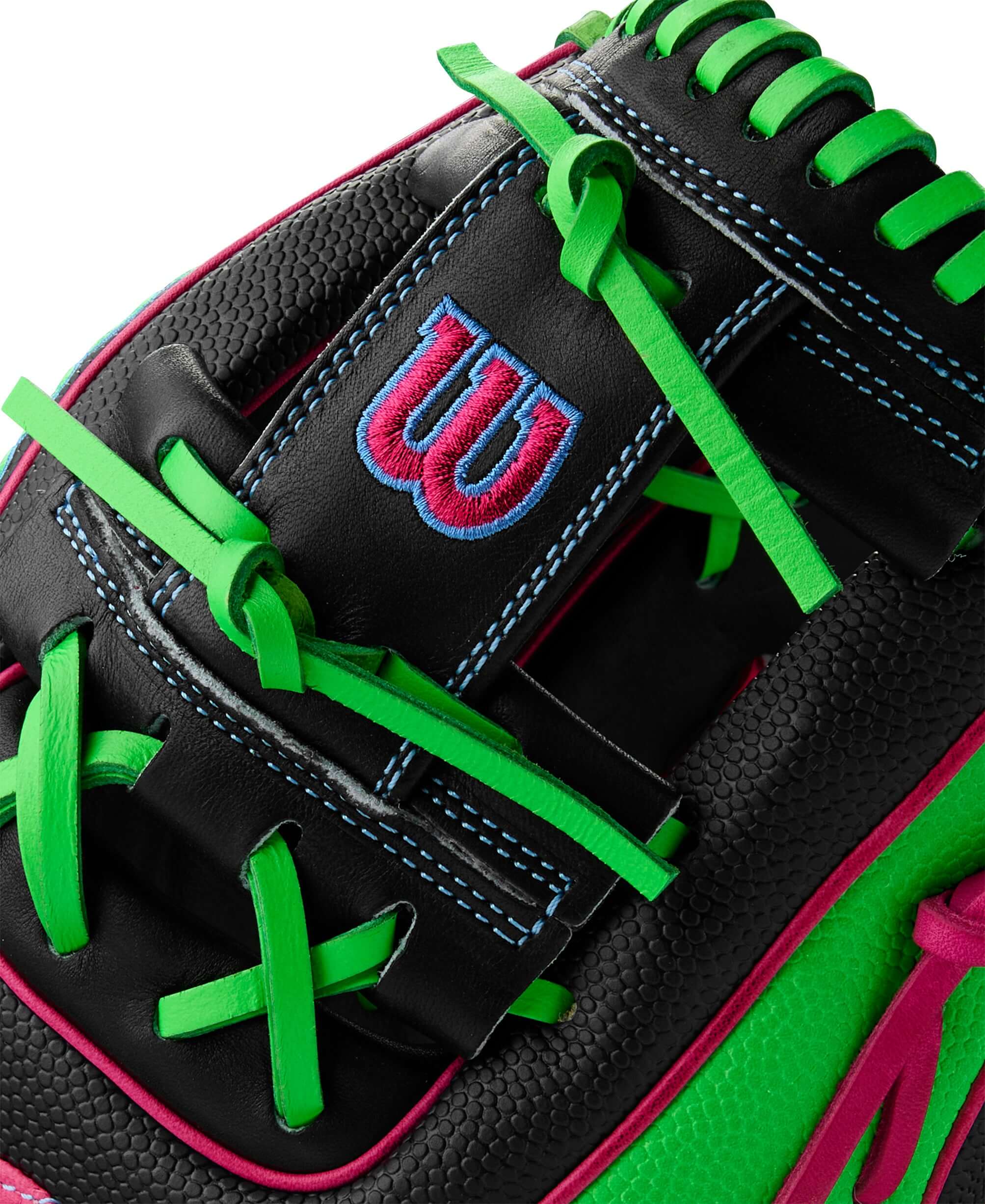 Close-up of Wilson A2000 1786 baseball glove featuring black leather with neon green and pink accents.