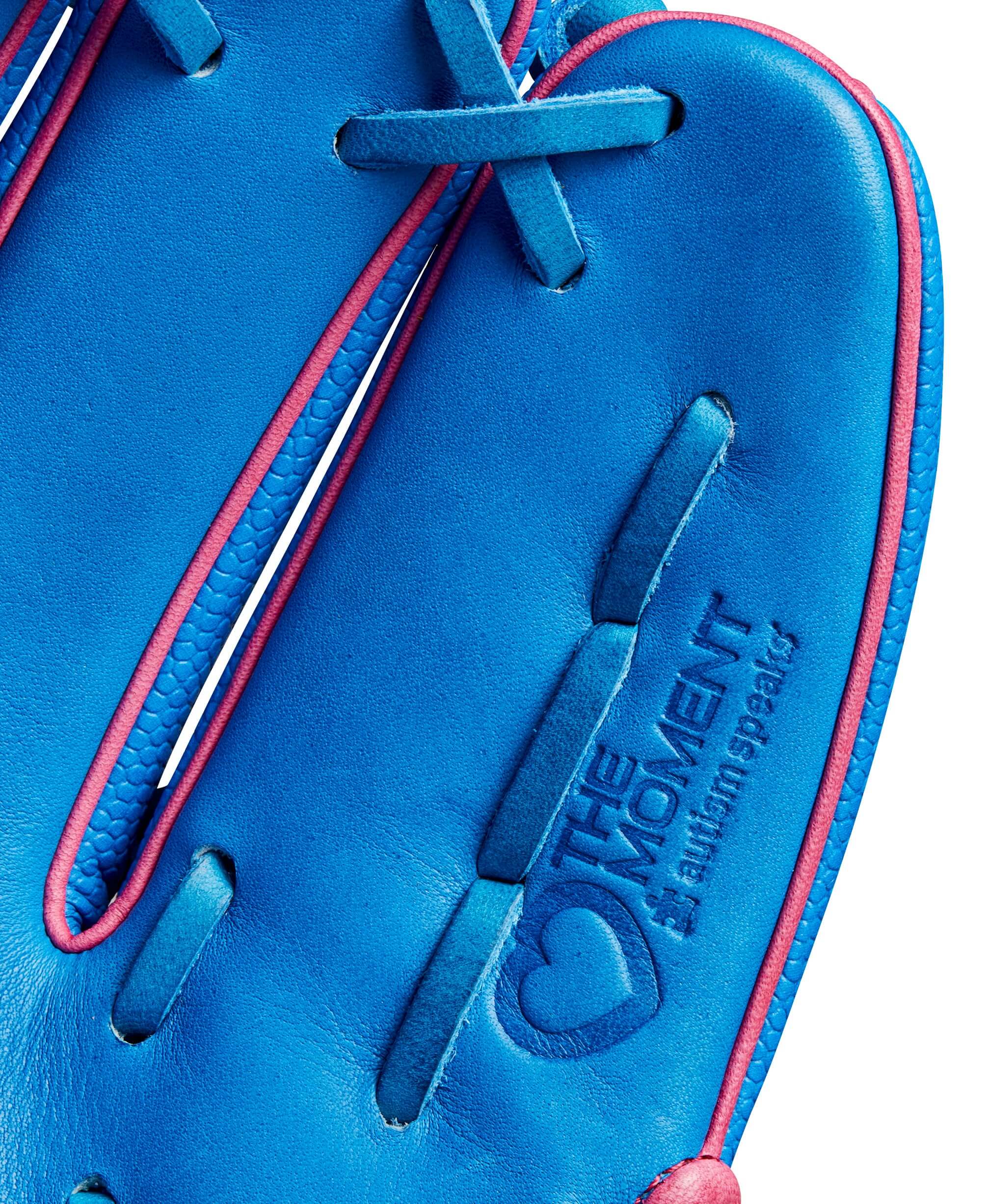 Close-up of the 2024 Autism Speaks A2000 DP15SS glove featuring blue leather with pink accents and embossed slogan.