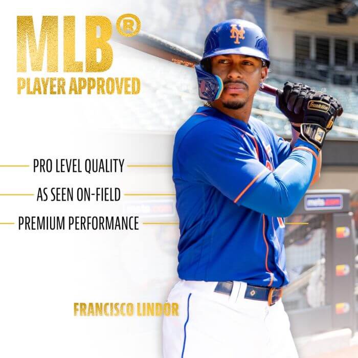 MLB player Francisco Lindor showcasing pro-level batting gloves with a baseball bat in a stadium.