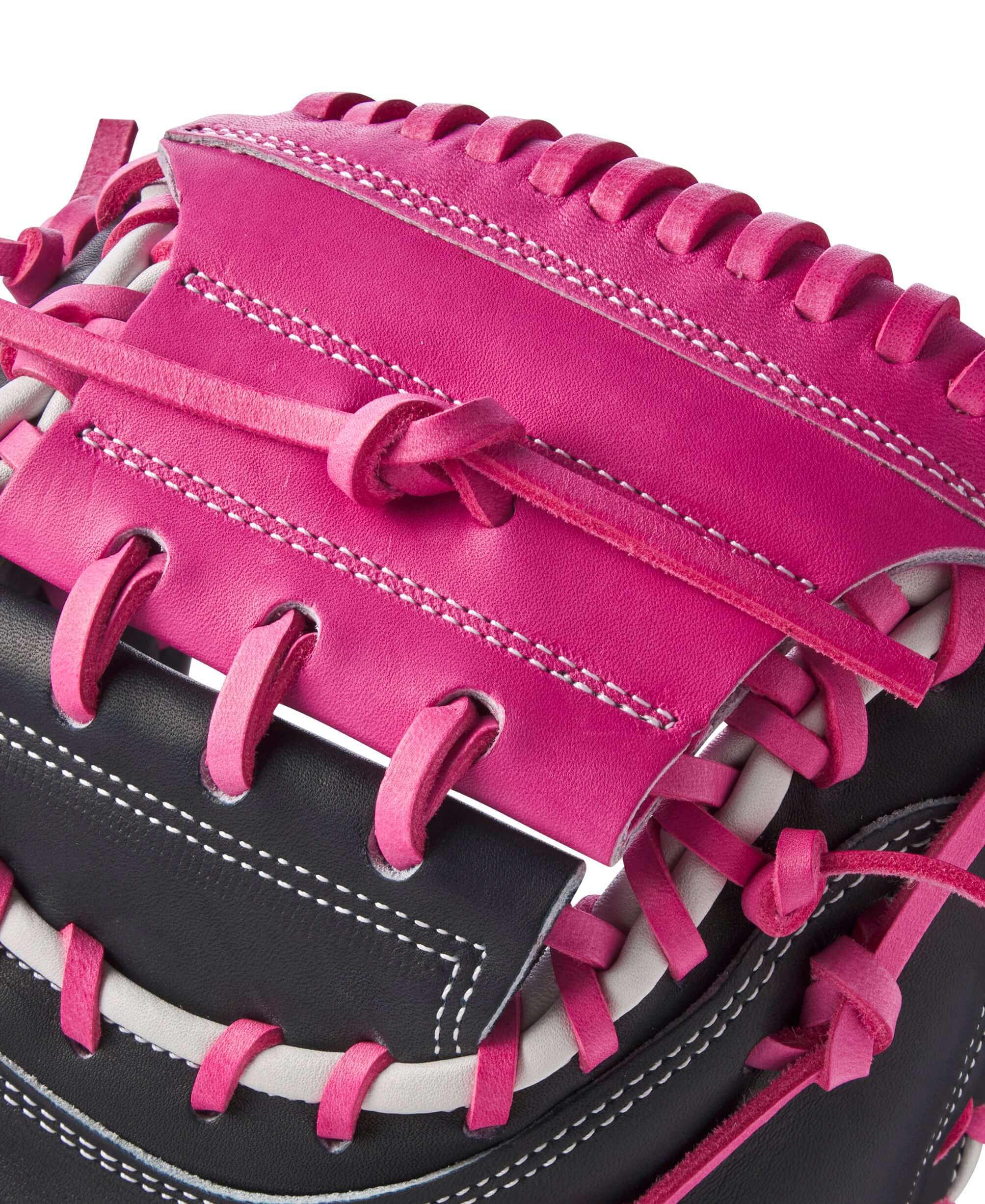 Close-up of Wilson A2K M23 catcher's mitt showing pink lacing and leather detail for enhanced grip and performance.