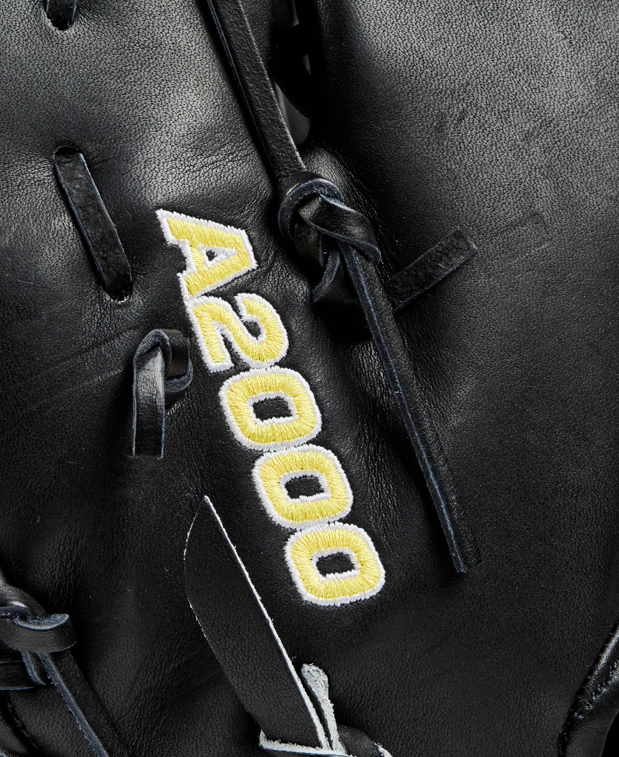 Close-up of Wilson A2000 baseball glove detailing with black leather and yellow stitching.