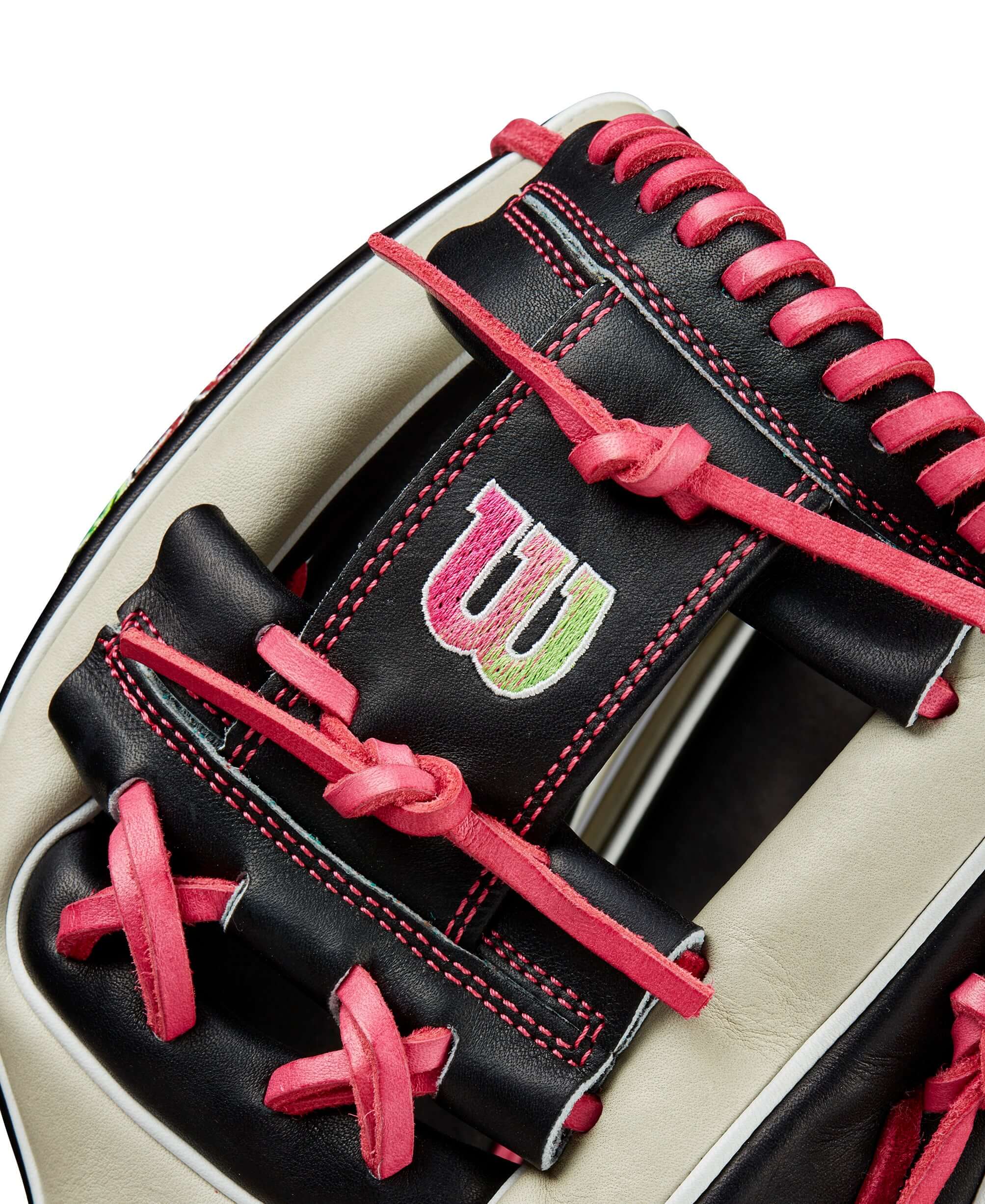 Close-up of Wilson A2K 1724 glove, featuring bold logos and unique pink lacing detail.