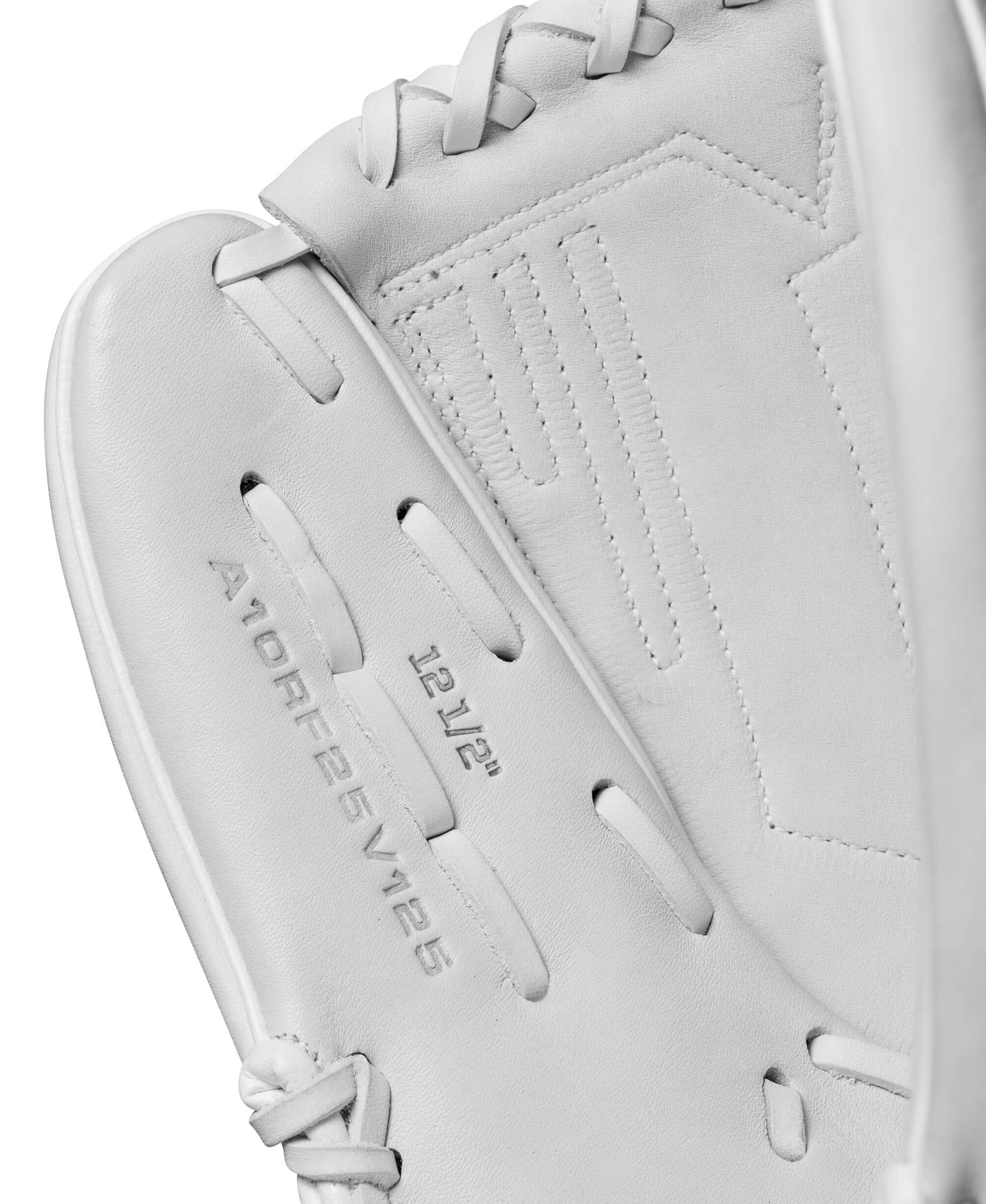 Close-up of Wilson A1000FP V125 12.5" fastpitch softball glove in white, showcasing its embossed details and construction.