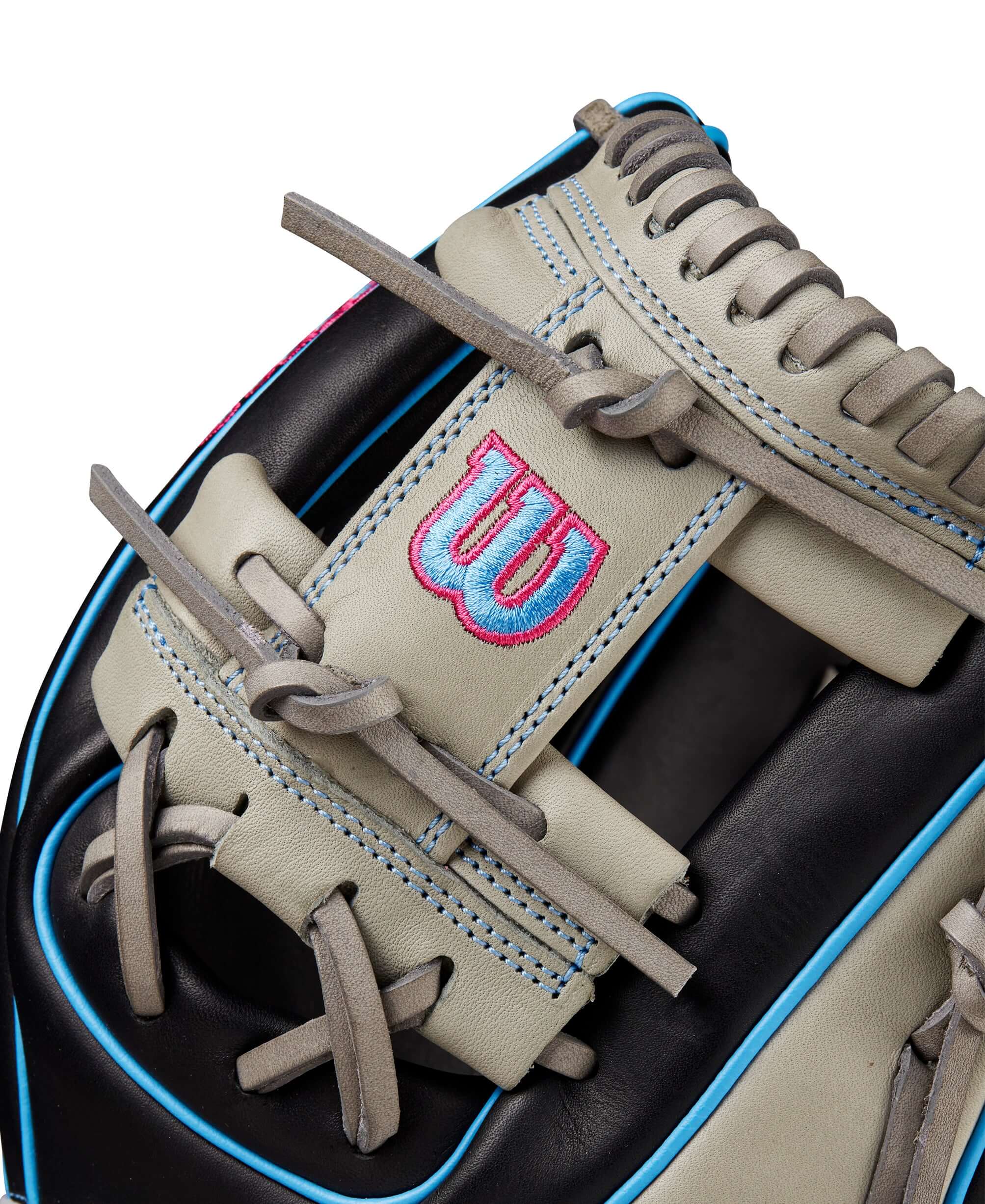 Close-up of Wilson A1000 DP15 glove showing leather texture and H-Web design in black, grey, and cool blue.