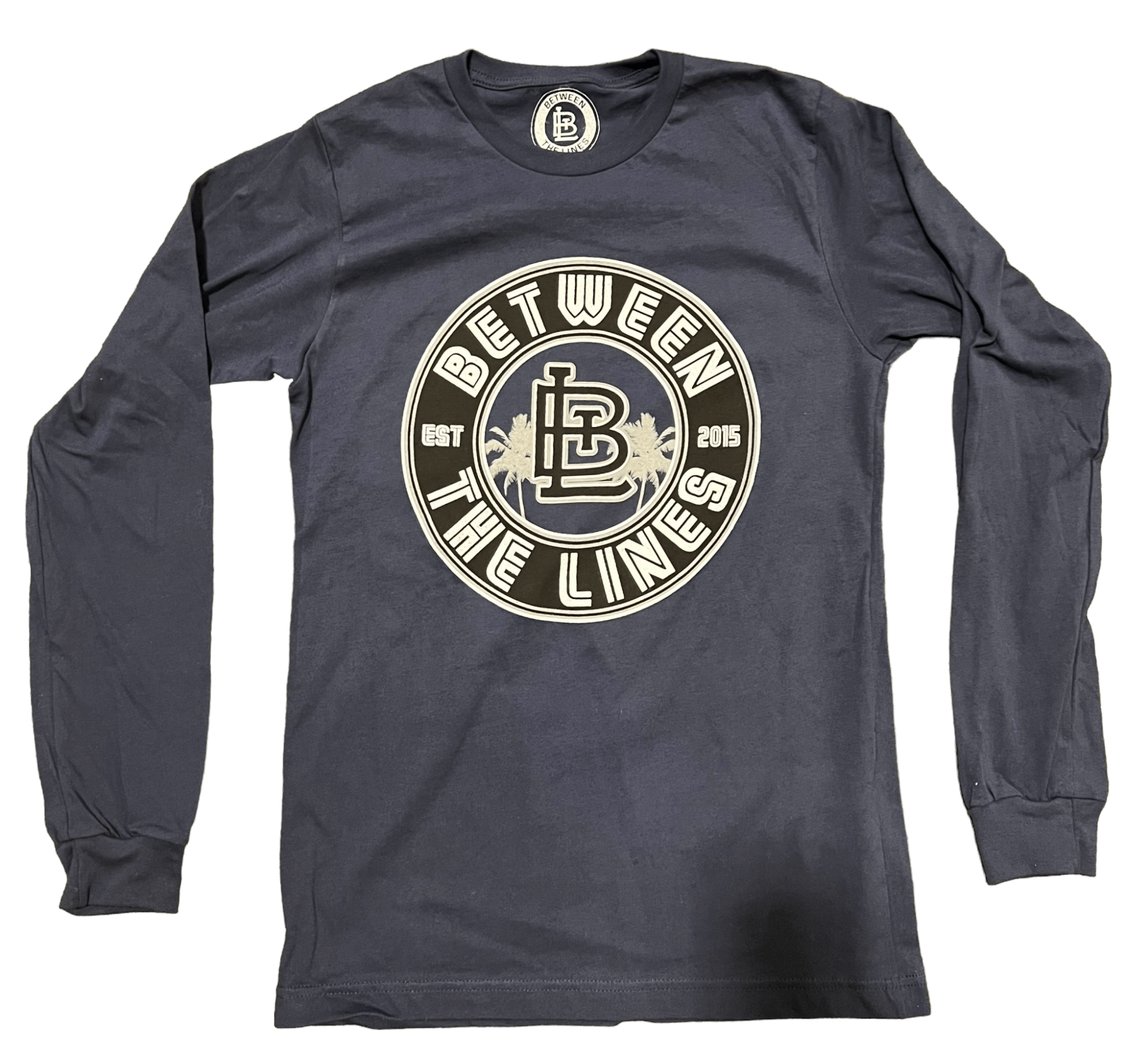 Between The Lines Long Sleeve Palm Tree top, navy blue with logo, perfect for casual outings and comfort.