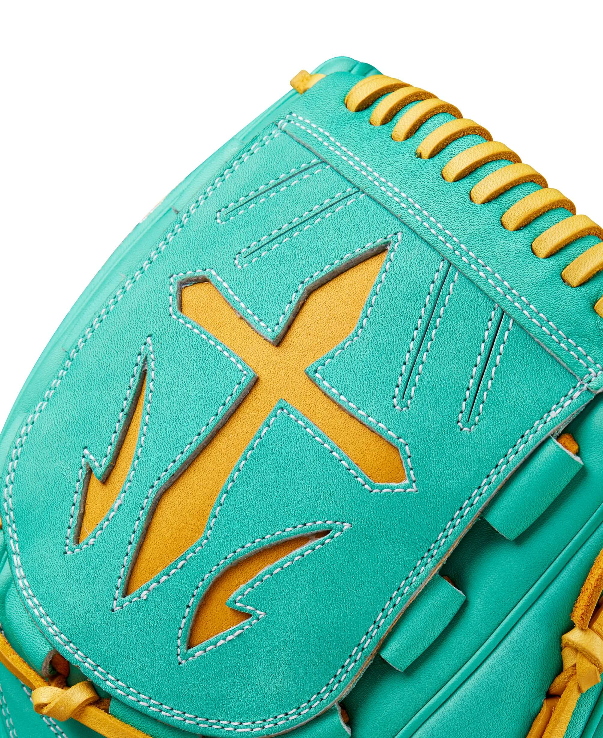 Close-up of Wilson A2000 B23 pitcher's glove with unique turquoise and gold design features.