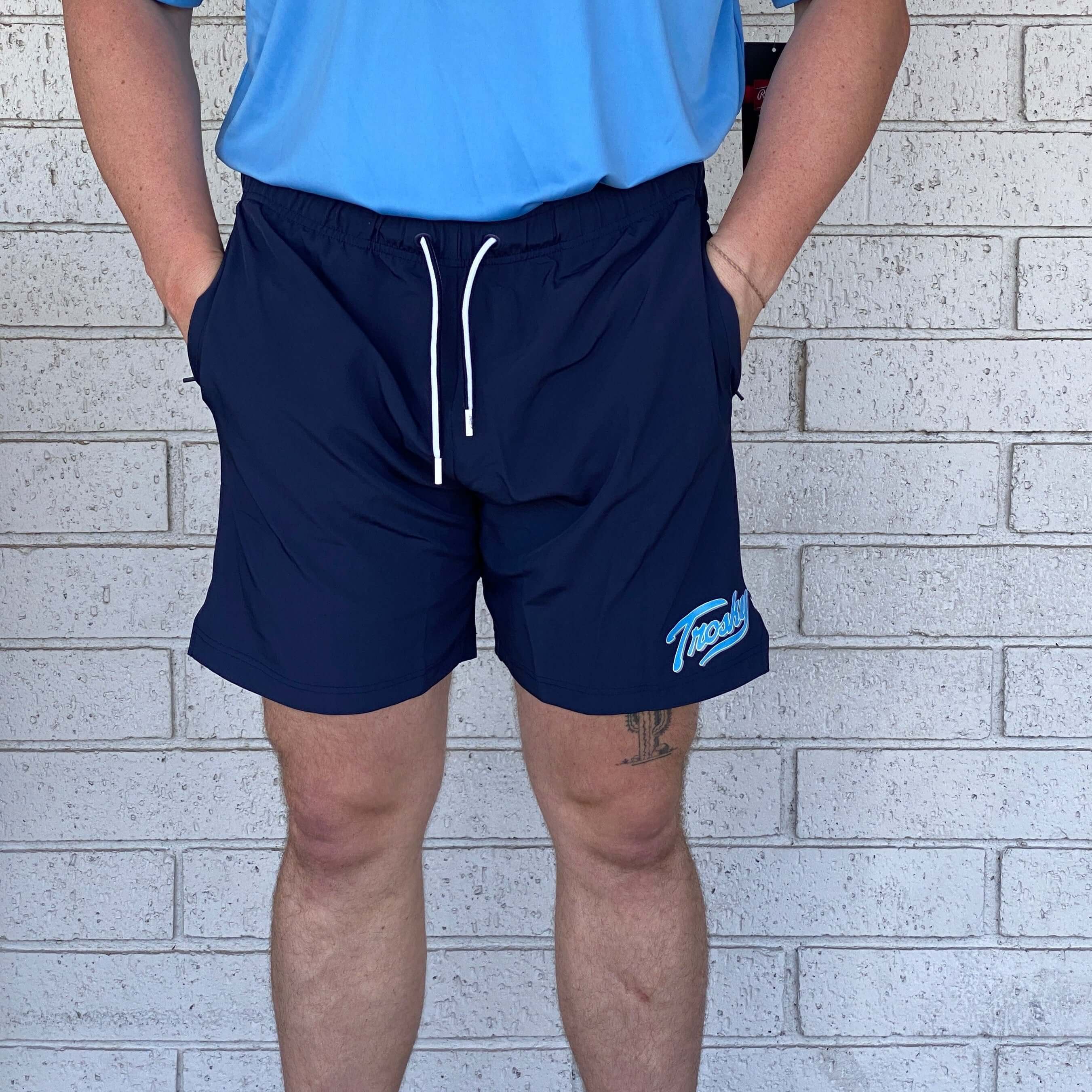 Rawlings Trosky Shorts in navy on model, showcasing contemporary athletic fit and pockets for active lifestyle.