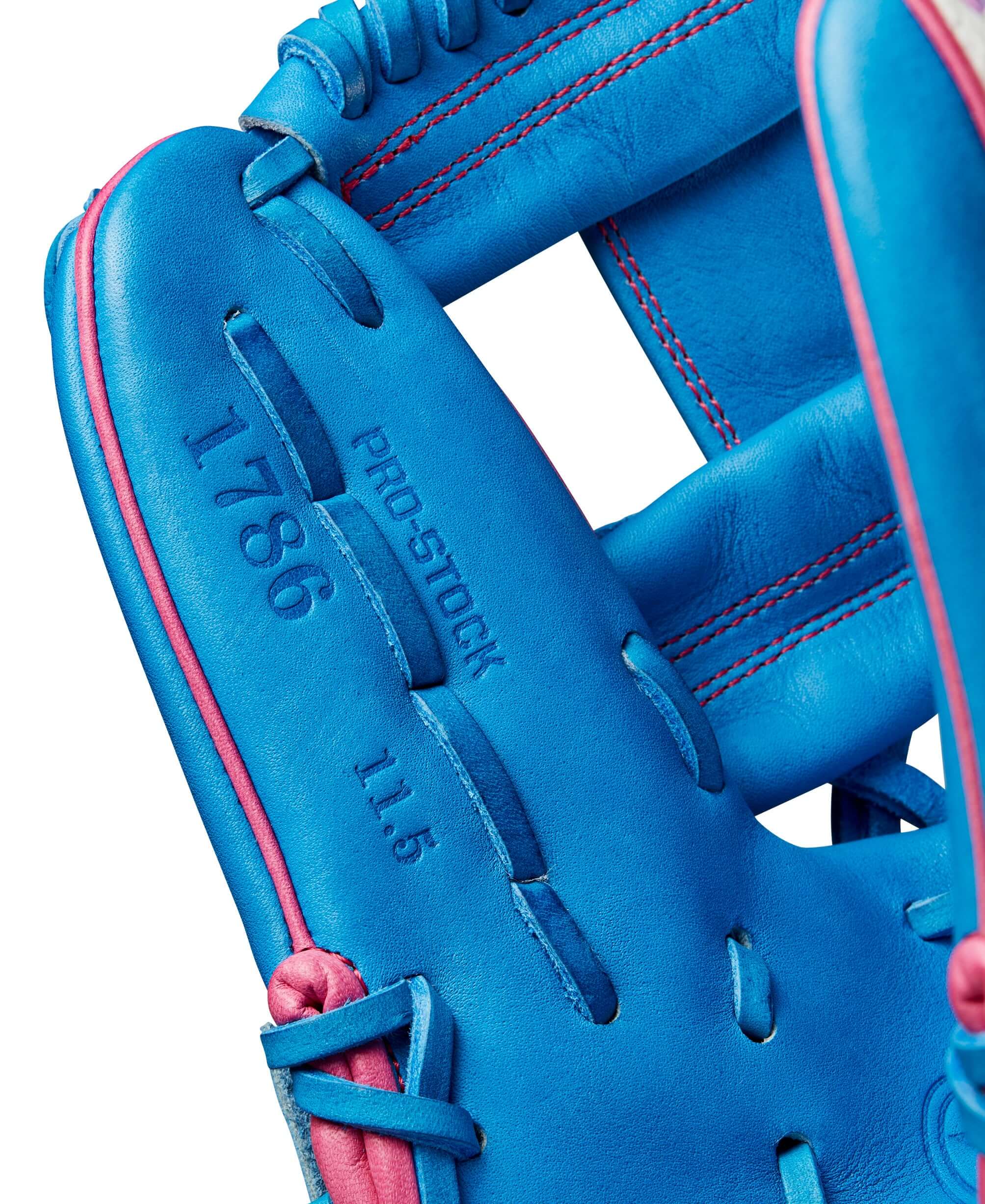 Close-up of the Wilson 2024 Autism Speaks A2000 1786 infield glove showing blue leather and pink stitching details.