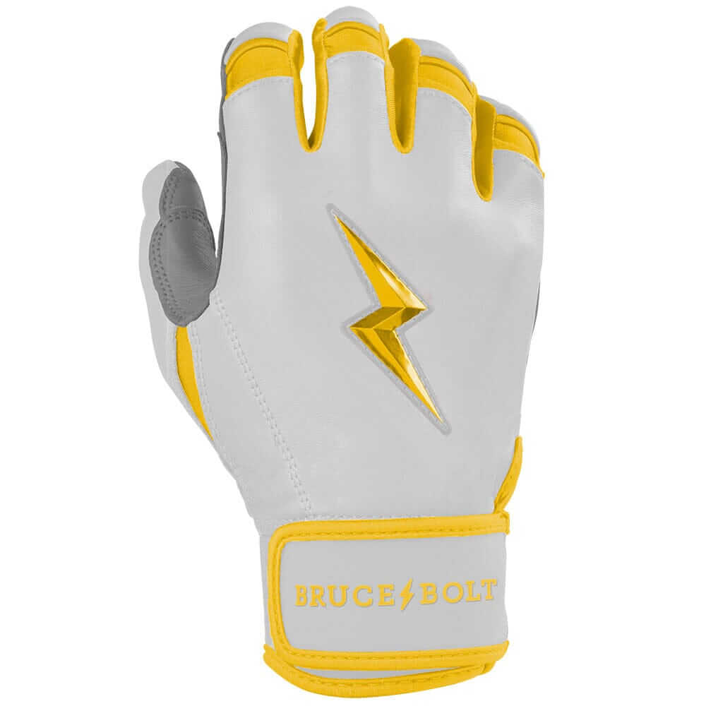 Close-up view of the right hand wearing Bruce Bolt Youth Premium Pro Chrome Short Cuff Batting Glove Yellow.