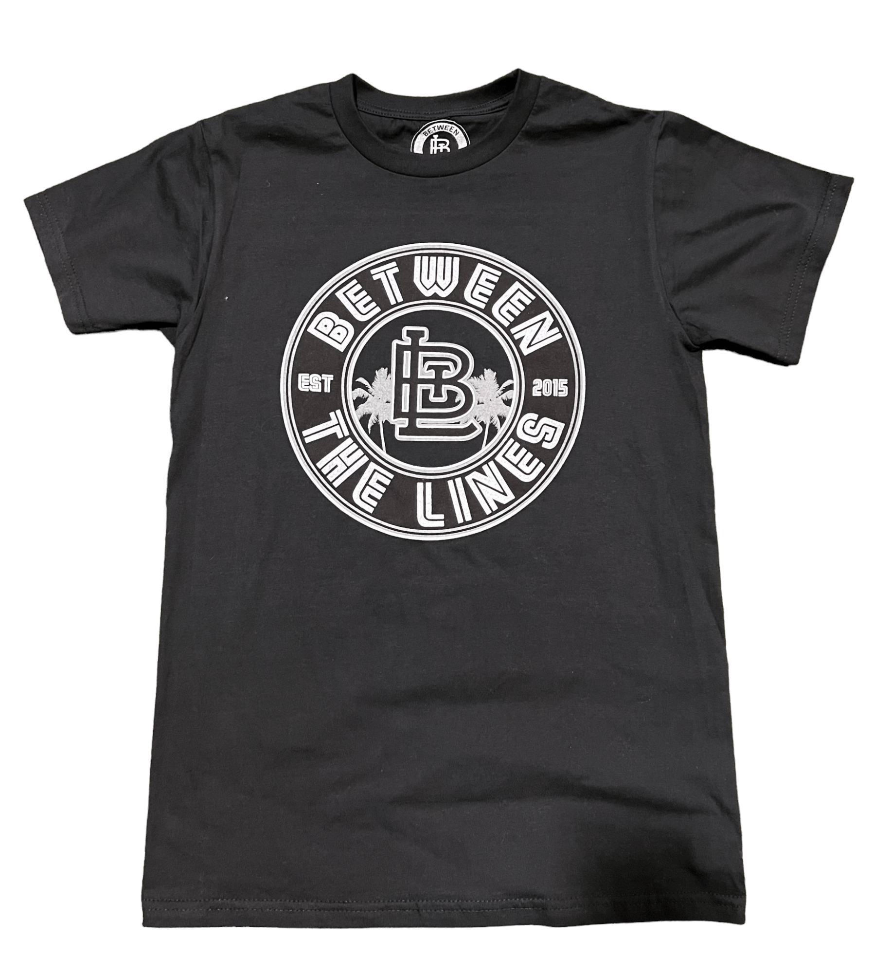 Black Between The Lines Palm Tree T-Shirt featuring a circular logo design with "EST 2015" and palm tree elements.