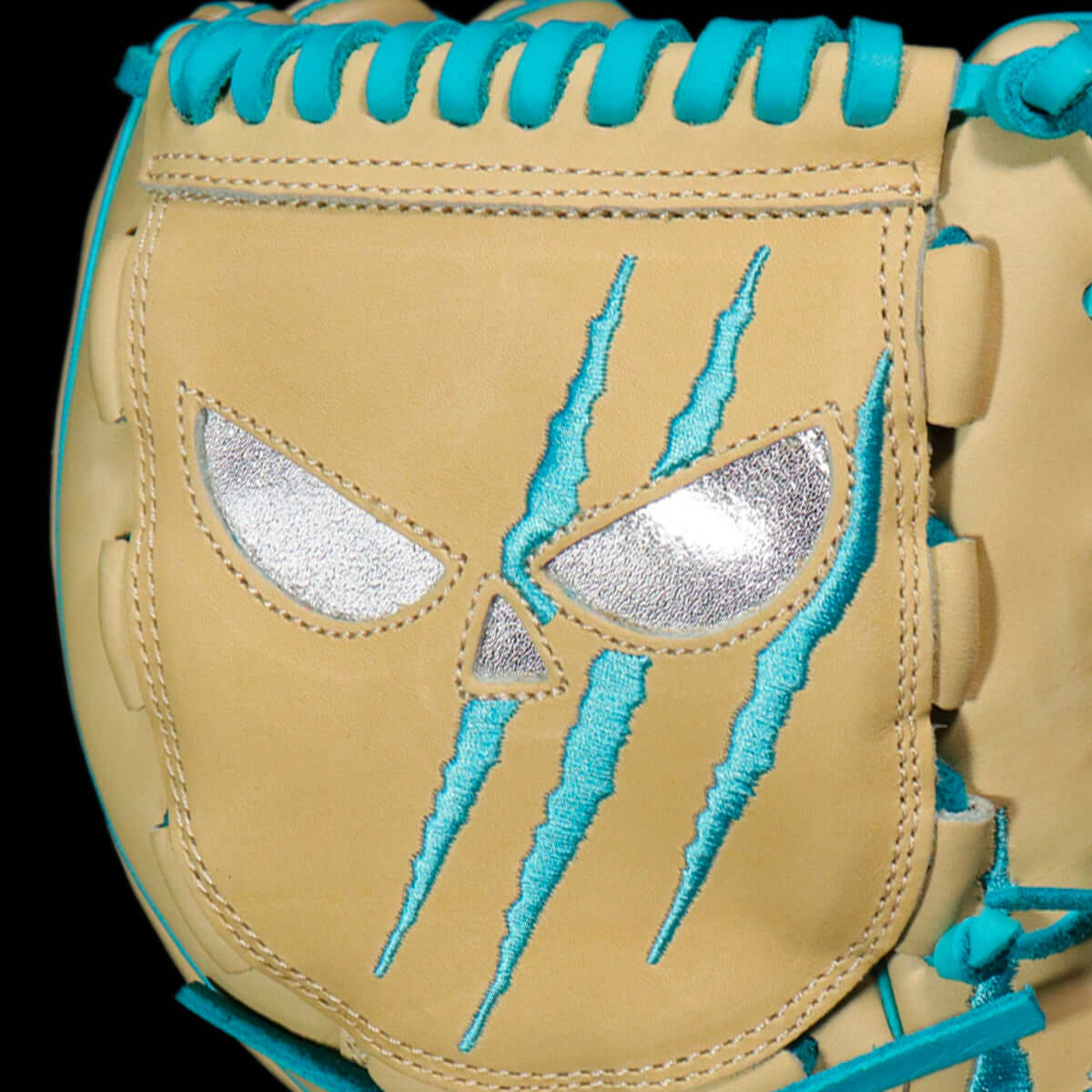 Close-up of Shadow 12 Sub Zero Pitcher's Glove showing fierce design with chrome skull and blue claw marks on blonde leather.