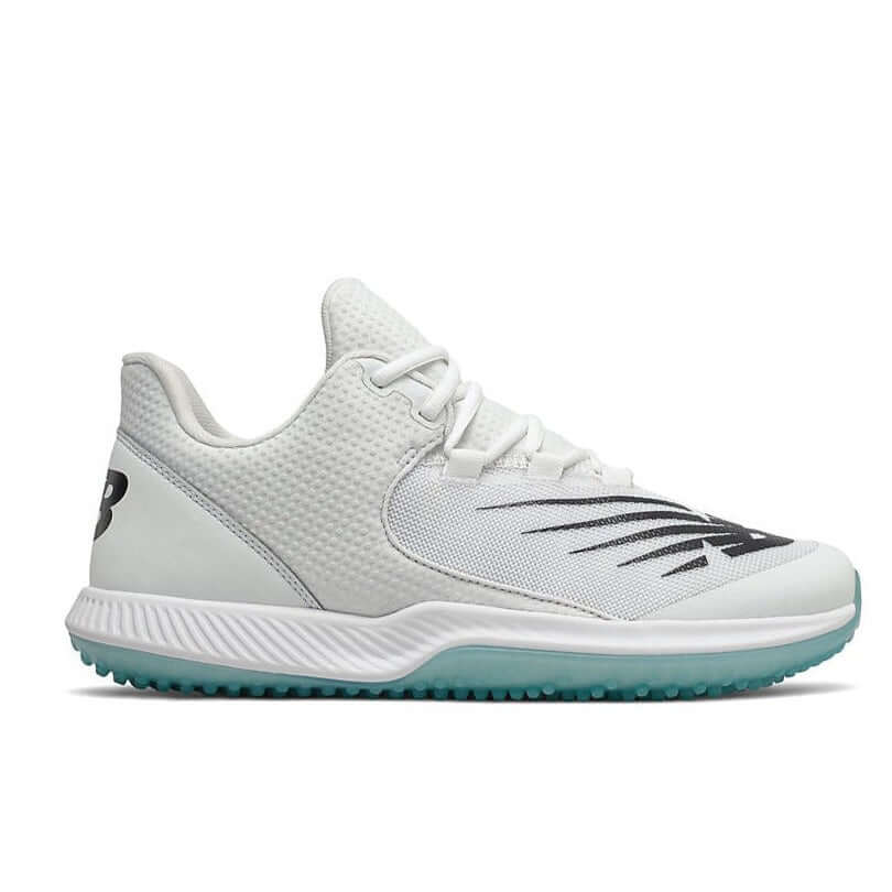 New Balance FuelCell T4040v6 baseball turf shoes in white and black, featuring a synthetic upper and rubber outsole for traction.