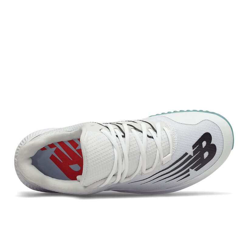 New Balance FuelCell T4040v6 baseball turf shoes showcasing the sleek white and black upper design and burrito tongue construction.