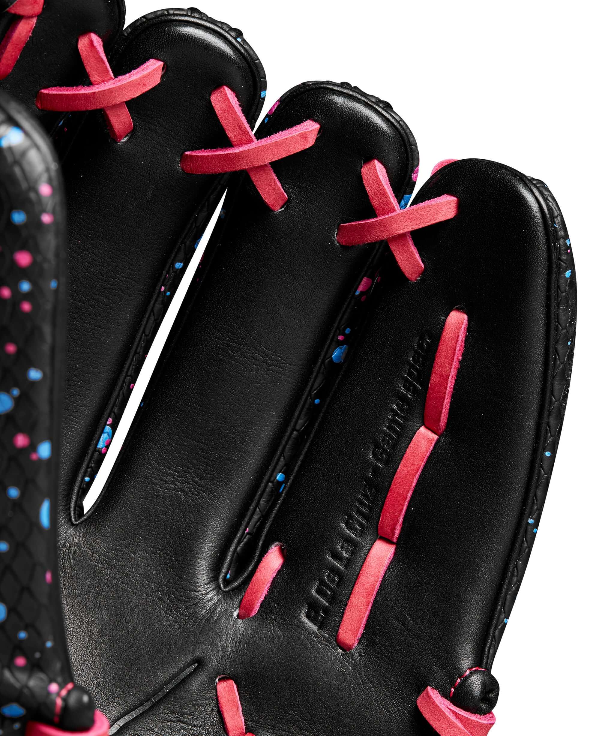 Close-up of Wilson Fall 2024 A2000 Elly De La Cruz 12" glove showing black leather and pink, blue accents on laces.