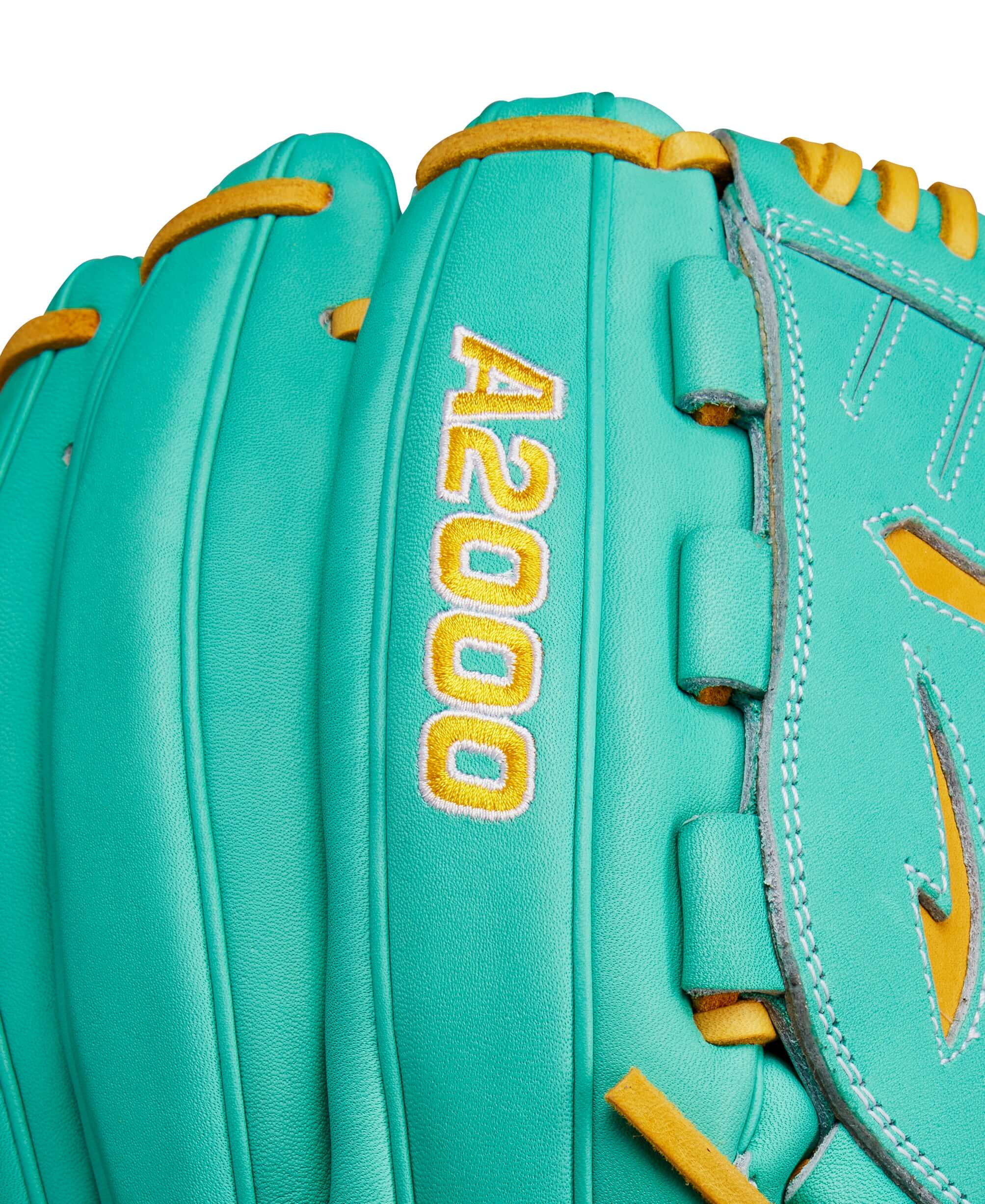 Close-up of Wilson A2000 B23 pitcher's glove in seafoam and yellow detailing, showcasing quality craftsmanship.