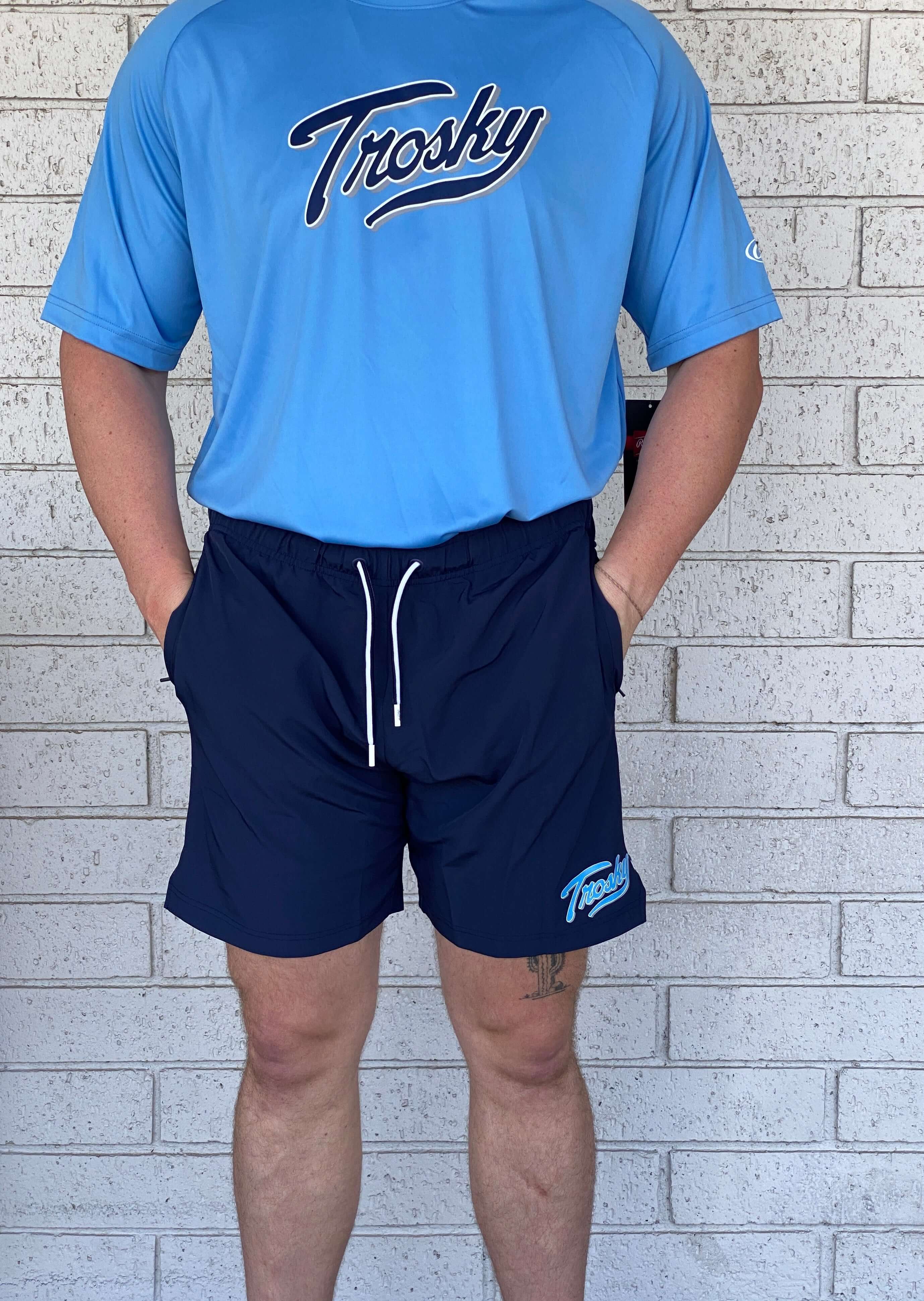 Rawlings Trosky Shorts in navy, paired with a light blue shirt, showcasing a contemporary athletic fit.
