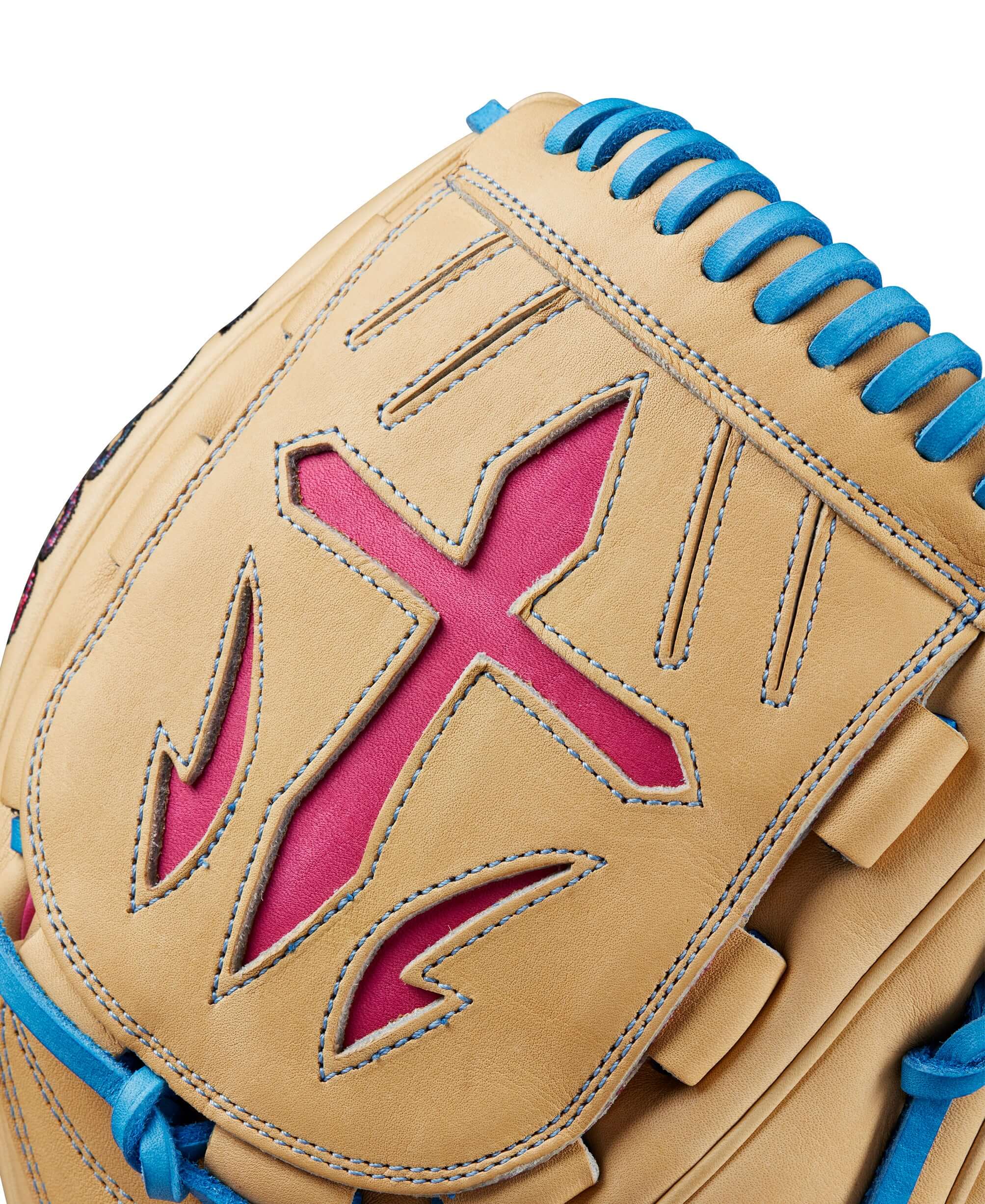 Close-up of the Wilson A2000 B23 glove with blonde leather, pink accents, and blue stitching details.